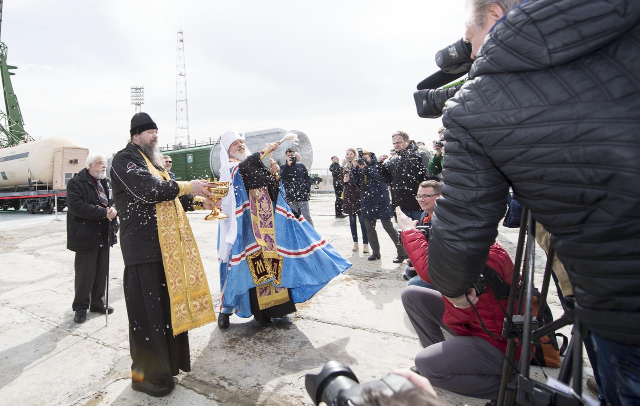 An Orthodox Priest blesses members of the media at the Baikonur Cosmodrome launch pad, Tuesday, March 20, 2018 in Baikonur, Kazahstan. Expedition 55 Soyuz Commander Oleg Artemyev of Roscosmos, Ricky Arnold and Drew Feustel of NASA are scheduled to launch to the International Space Station aboard the Soyuz MS-08 spacecraft on Wednesday, March, 21. Photo Credit: (NASA/Joel Kowsky)