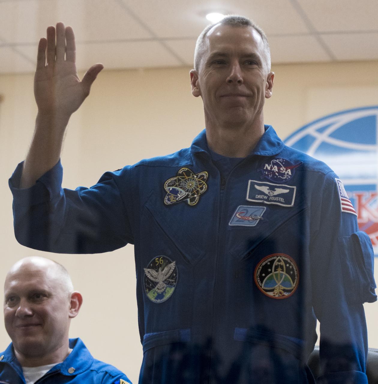 Expedition 55 flight engineer Drew Feustel is seen in quarantine, behind glass, during a press conference, Tuesday, March 20, 2018 a the Cosmonaut Hotel in Baikonur, Kazakhstan. Feustel, Soyuz Commander Oleg Artemyev of Roscosmos, and flight engineer Ricky Arnold of NASA are scheduled to launch to the International Space Station aboard the Soyuz MS-08 spacecraft on Wednesday, March, 21. Photo Credit: (NASA/Joel Kowsky)