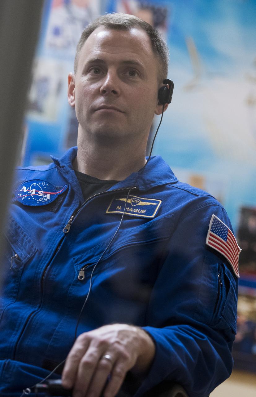 Expedition 55 backup crew member Nick Hague of NASA is seen in quarantine, behind glass, during a press conference, Tuesday, March 20, 2018 a the Cosmonaut Hotel in Baikonur, Kazakhstan. Expedition 55 Soyuz Commander Oleg Artemyev of Roscosmos, flight engineer Ricky Arnold and flight engineer Drew Feustel of NASA are scheduled to launch to the International Space Station aboard the Soyuz MS-08 spacecraft on Wednesday, March, 21. Photo Credit: (NASA/Joel Kowsky)