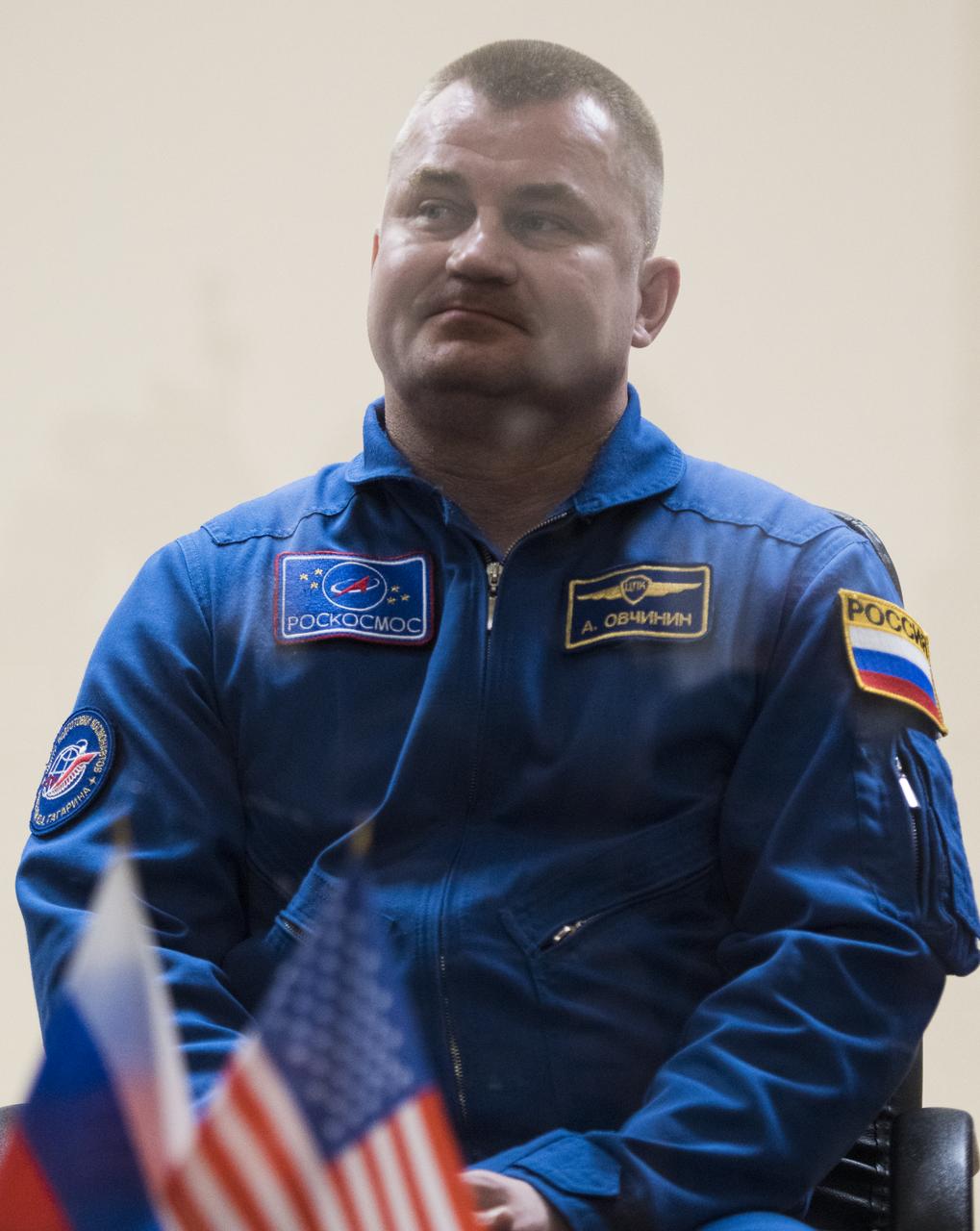 Expedition 55 backup crew member Alexey Ovchinin of Roscosmos is seen in quarantine, behind glass, during a press conference, Tuesday, March 20, 2018 a the Cosmonaut Hotel in Baikonur, Kazakhstan. Expedition 55 Soyuz Commander Oleg Artemyev of Roscosmos, flight engineer Ricky Arnold and flight engineer Drew Feustel of NASA are scheduled to launch to the International Space Station aboard the Soyuz MS-08 spacecraft on Wednesday, March, 21. Photo Credit: (NASA/Joel Kowsky)
