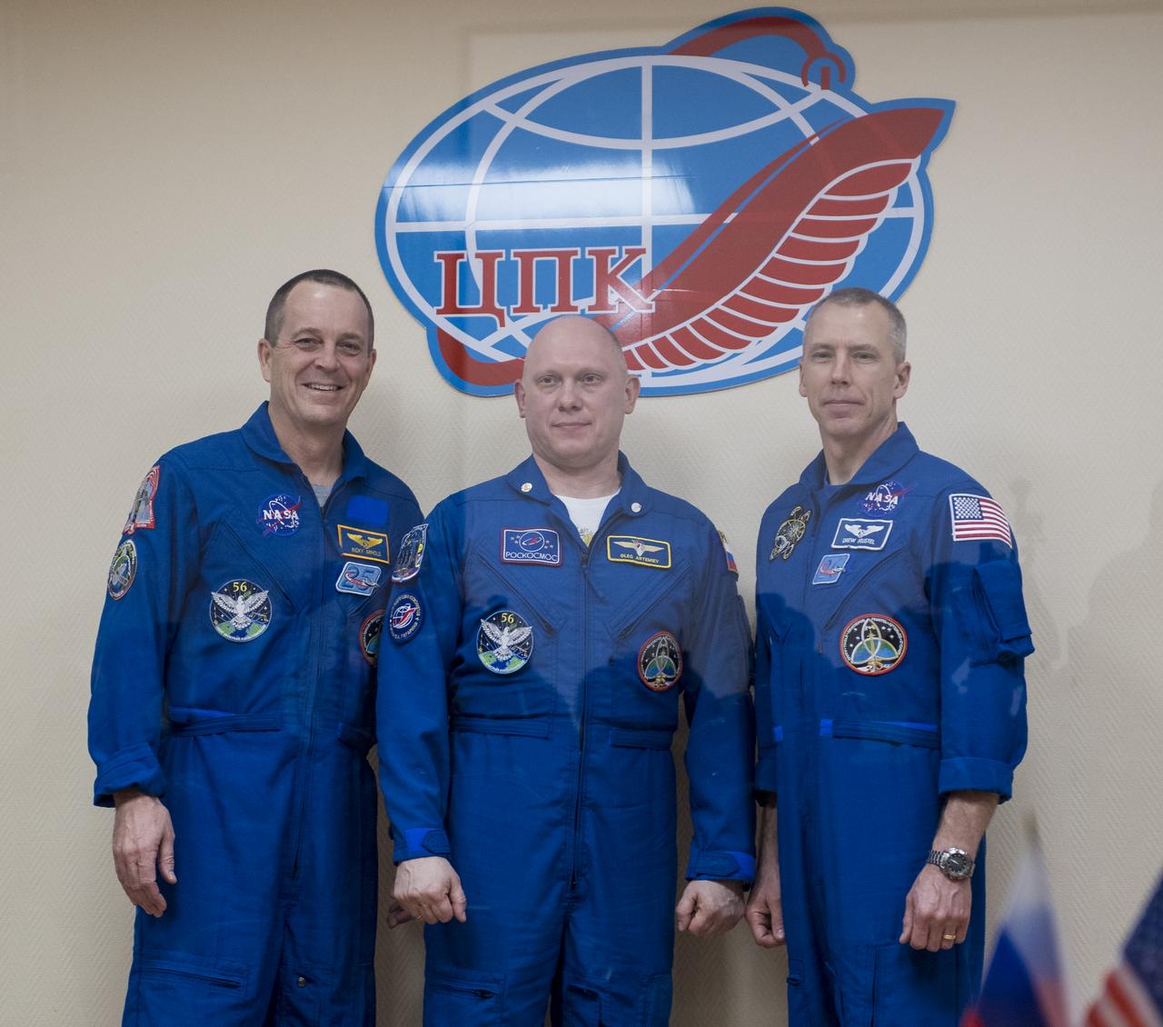 Expedition 55 flight engineer Ricky Arnold of NASA, left, Soyuz Commander Oleg Artemyev of Roscosmos, center, and flight engineer Drew Feustel of NASA, right, pose for a picture at the conclusion of a press conference, Tuesday, March 20, 2018 a the Cosmonaut Hotel in Baikonur, Kazakhstan. Arnold, Artemyev, and Feustel are scheduled to launch to the International Space Station aboard the Soyuz MS-08 spacecraft on Wednesday, March, 21.  Photo Credit: (NASA/Joel Kowsky)