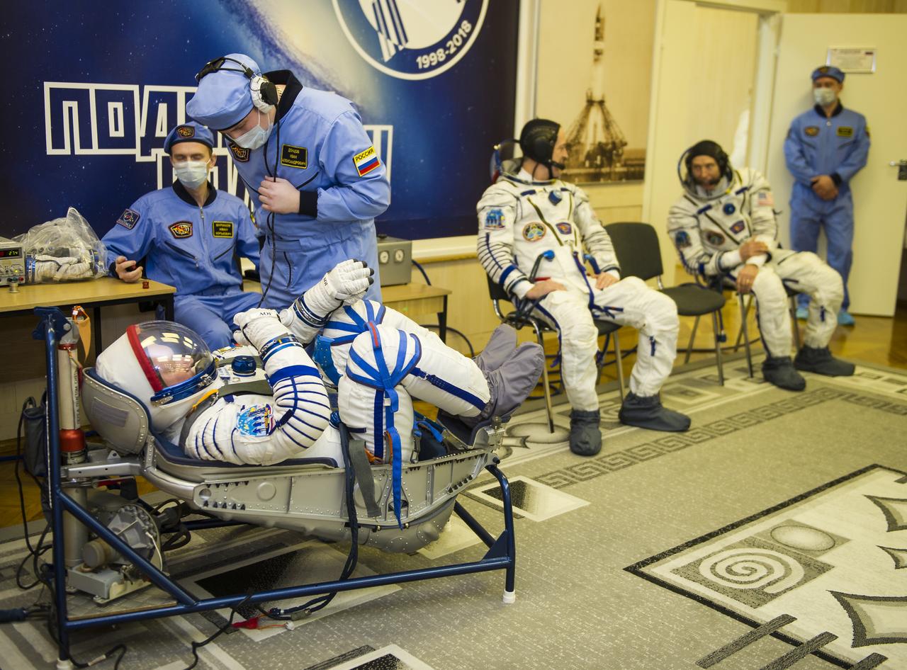 Expedition 55 Soyuz Commander Oleg Artemyev of Roscosmos prepares to have his Russian Sokol suit pressure checked in preparation for launch aboard the Soyuz MS-08 spacecraft, Wednesday, March 21, 2018 at the Baikonur Cosmodrome  Kazakhstan. Artemyev and flight engineers Drew Feustel and Ricky Arnold of NASA launched aboard the Soyuz MS-08 spacecraft at 1:44 p.m. Eastern time (11:44 p.m. Baikonur time) on March 21 to begin their journey to the International Space Station.  Photo Credit: (NASA/GCTC/Irina Peshkova)