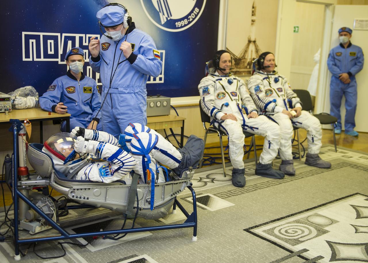 Expedition 55 flight engineer Drew Feustel of NASA prepares to have his Russian Sokol suit pressure checked in preparation for launch aboard the Soyuz MS-08 spacecraft, Wednesday, March 21, 2018 at the Baikonur Cosmodrome Kazakhstan. Feustel, Soyuz Commander Oleg Artemyev of Roscosmos, and flight engineer Ricky Arnold of NASA launched aboard the Soyuz MS-08 spacecraft at 1:44 p.m. Eastern time (11:44 p.m. Baikonur time) on March 21 to begin their journey to the International Space Station. Photo Credit: (NASA/GCTC/Irina Peshkova)