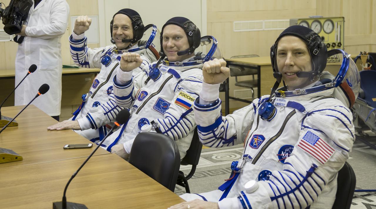 Expedition 55 flight engineer Ricky Arnold of NASA, left, Soyuz Commander Oleg Artemyev of Roscosmos, center, and flight engineer Drew Feustel of NASA, right, are seen after having their Russian Sokol suits pressure checked in preparation for launch aboard the Soyuz MS-08 spacecraft, Wednesday, March 21, 2018 at the Baikonur Cosmodrome Kazakhstan. Arnold, Artemyev, and Feustel launched aboard the Soyuz MS-08 spacecraft at 1:44 p.m. Eastern time (11:44 p.m. Baikonur time) on March 21 to begin their journey to the International Space Station. Photo Credit: (NASA/Victor Zelentsov)