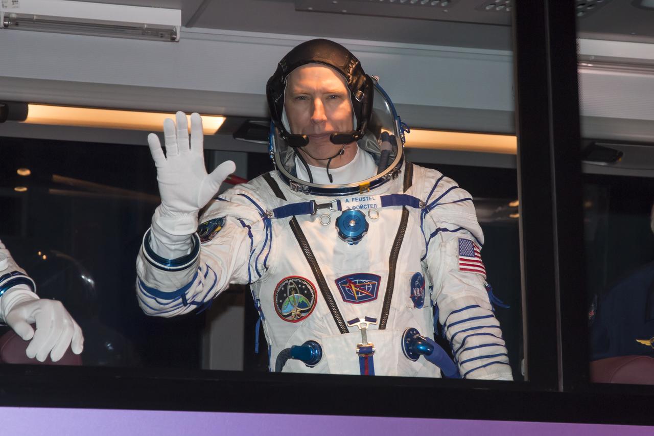 Expedition 55 flight engineer Drew Feustel of NASA waves farewell to family and friends as he and Soyuz Commander Oleg Artemyev of Roscosmos and flight engineer Ricky Arnold of NASA depart for the launch pad a few hours before their launch, Wednesday, March 21, 2018 at the Baikonur Cosmodrome Kazakhstan. Launch of the Soyuz rocket will send Feustel, Artemyev, and Arnold on a five month mission aboard the International Space Station. Photo Credit: (NASA/Victor Zelentsov)