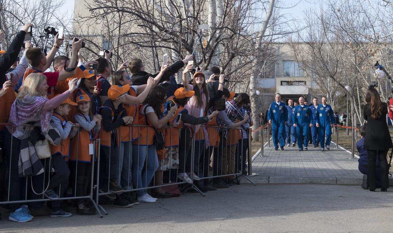 Expedition 55 flight engineer Ricky Arnold of NASA, left, Soyuz Commander Oleg Artemyev of Roscosmos, center, and flight engineer Drew Feustel of NASA, right, are seen as they depart the Cosmonaut Hotel to suit-up for their Soyuz launch to the International Space Station, Wednesday, March 21, 2018 in Baikonur, Kazakhstan. Arnold, Artemyev, and Feustel launched aboard the Soyuz MS-08 spacecraft at 1:44 p.m. Eastern time (11:44 p.m. Baikonur time) on March 21 to begin their journey to the International Space Station.  Photo Credit: (NASA/Joel Kowsky)