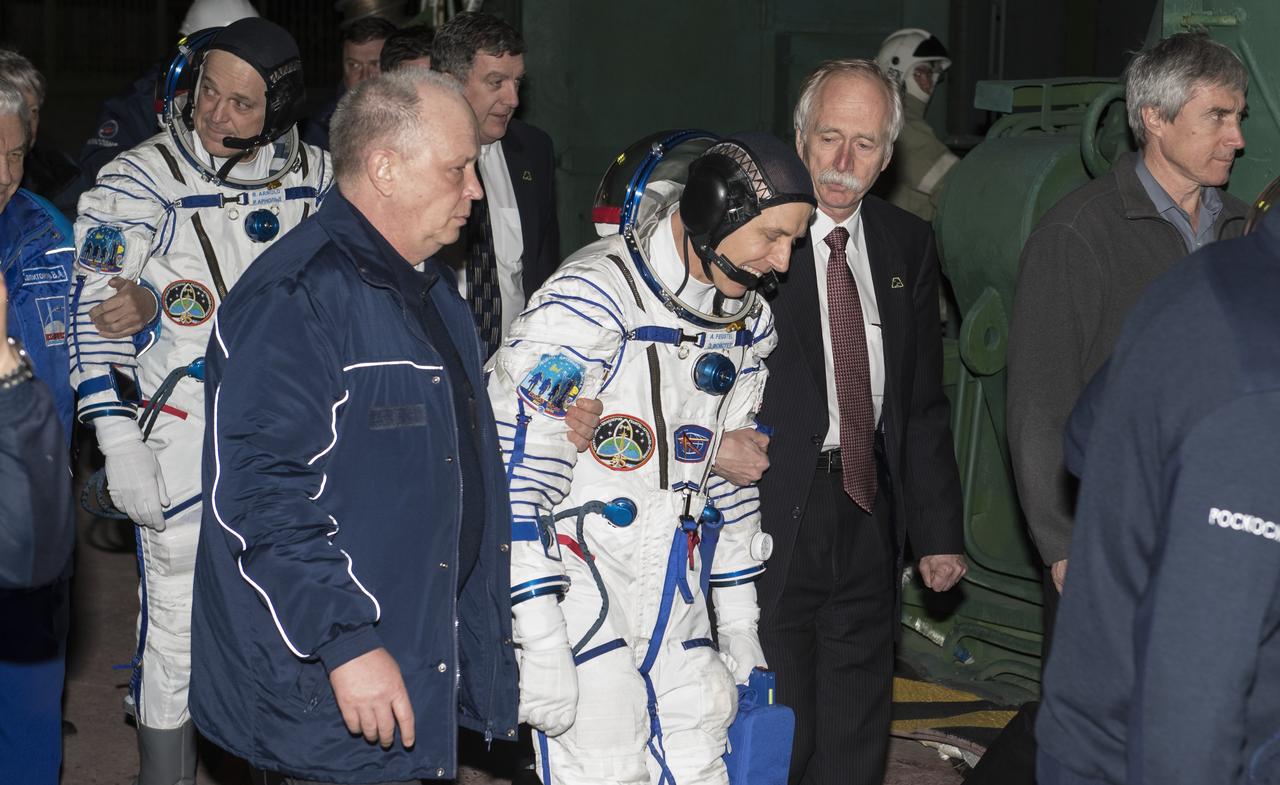 NASA Associate Administrator for the Human Exploration and Operations Mission Directorate Bill Gerstenmaier escorts Expedition 55 flight engineer Drew Feustel of NASA as he prepares to board the Soyuz MS-08 spacecraft for launch, Wednesday, March 21, 2018 at the Baikonur Cosmodrome in Kazakhstan. Feustel and his crewmates Ricky Arnold of NASA and Oleg Artemyev of Roscosmos will spend the next five months living and working aboard the International Space Station. Photo Credit: (NASA/Joel Kowsky)