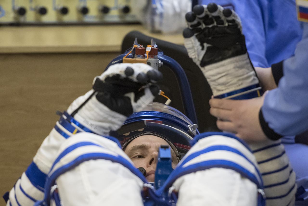 Expedition 55 flight engineer Drew Feustel of NASA prepares to have his Russian Sokol suit pressure checked in preparation for launch aboard the Soyuz MS-08 spacecraft, Wednesday, March 21, 2018 at the Baikonur Cosmodrome in Kazakhstan. Feustel, Soyuz Commander Oleg Artemyev of Roscosmos, and flight engineer Ricky Arnold of NASA launched aboard the Soyuz MS-08 spacecraft at 1:44 p.m. Eastern time (11:44 p.m. Baikonur time) on March 21 to begin their journey to the International Space Station. Photo Credit: (NASA/Joel Kowsky)