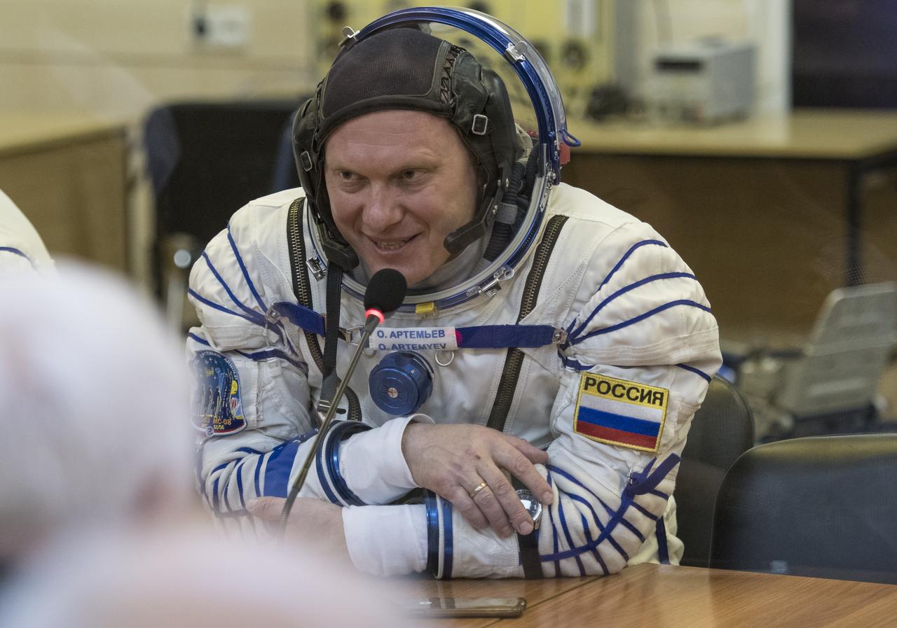 Expedition 55 Soyuz Commander Oleg Artemyev of Roscosmos speaks with family and friends after having his Russian Sokol suit pressure checked in preparation for launch aboard the Soyuz MS-08 spacecraft, Wednesday, March 21, 2018 at the Baikonur Cosmodrome in Kazakhstan. Artemyev and flight engineers Drew Feustel and Ricky Arnold of NASA launched aboard the Soyuz MS-08 spacecraft at 1:44 p.m. Eastern time (11:44 p.m. Baikonur time) on March 21 to begin their journey to the International Space Station.  Photo Credit: (NASA/Joel Kowsky)