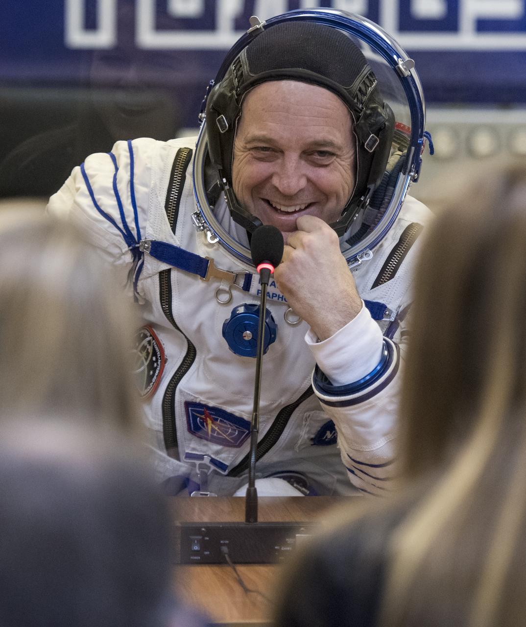 Expedition 55 flight engineer Ricky Arnold of NASA speaks with family and friends after having his Russian Sokol suit pressure checked in preparation for launch aboard the Soyuz MS-08 spacecraft, Wednesday, March 21, 2018 at the Baikonur Cosmodrome in Kazakhstan. Arnold, Soyuz Commander Oleg Artemyev of Roscosmos, and flight engineer Drew Feustel of NASA launched aboard the Soyuz MS-08 spacecraft at 1:44 p.m. Eastern time (11:44 p.m. Baikonur time) on March 21 to begin their journey to the International Space Station.  Photo Credit: (NASA/Joel Kowsky)
