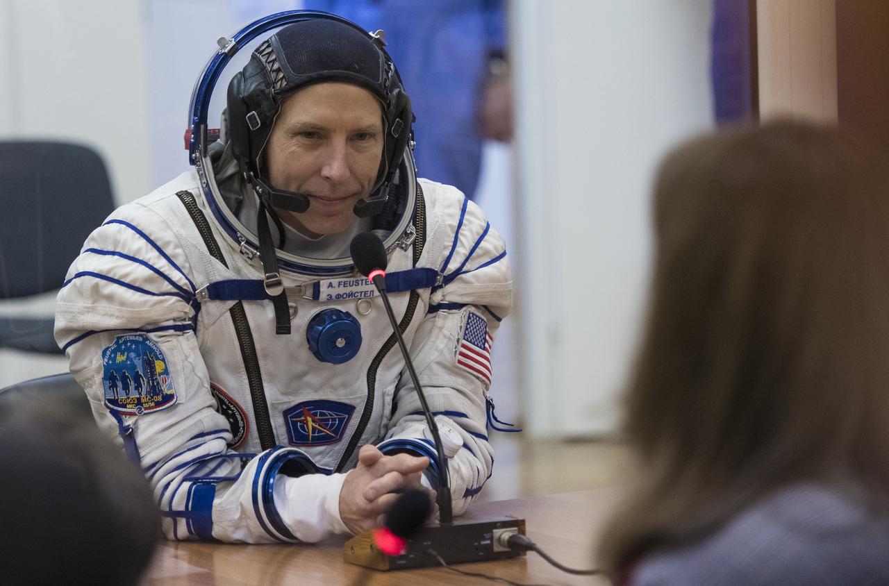 Expedition 55 flight engineer Drew Feustel of NASA speaks with family and friends after having his Russian Sokol suit pressure checked in preparation for launch aboard the Soyuz MS-08 spacecraft, Wednesday, March 21, 2018 at the Baikonur Cosmodrome in Kazakhstan. Feustel, Soyuz Commander Oleg Artemyev of Roscosmos, and flight engineer Ricky Arnold of NASA launched aboard the Soyuz MS-08 spacecraft at 1:44 p.m. Eastern time (11:44 p.m. Baikonur time) on March 21 to begin their journey to the International Space Station. Photo Credit: (NASA/Joel Kowsky)
