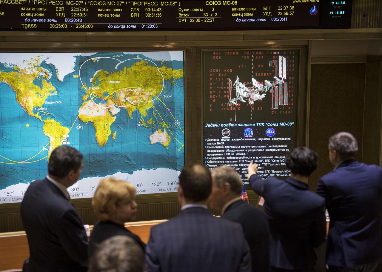 Guests watch a live view of the International Space Station, as seen by cameras onboard the Soyuz MS-08 spacecraft with Expedition 55-56 crewmembers Oleg Artemyev of Roscosmos and Ricky Arnold and Drew Feustel of NASA, on screens at the Moscow Mission Control Center as the spacecraft approaches for docking, Friday, March 23, 2018 in Korolev, Russia. The Soyuz MS-08 spacecraft carrying Artemyev, Feustel, and Arnold docked at 3:40 p.m. Eastern time (10:40 p.m. Moscow time) and joined Expedition 55 Commander Anton Shkaplerov of Roscosmos, Scott Tingle of NASA, and Norishige Kanai of the Japan Aerospace Exploration Agency (JAXA). Photo Credit: (NASA/Joel Kowsky)