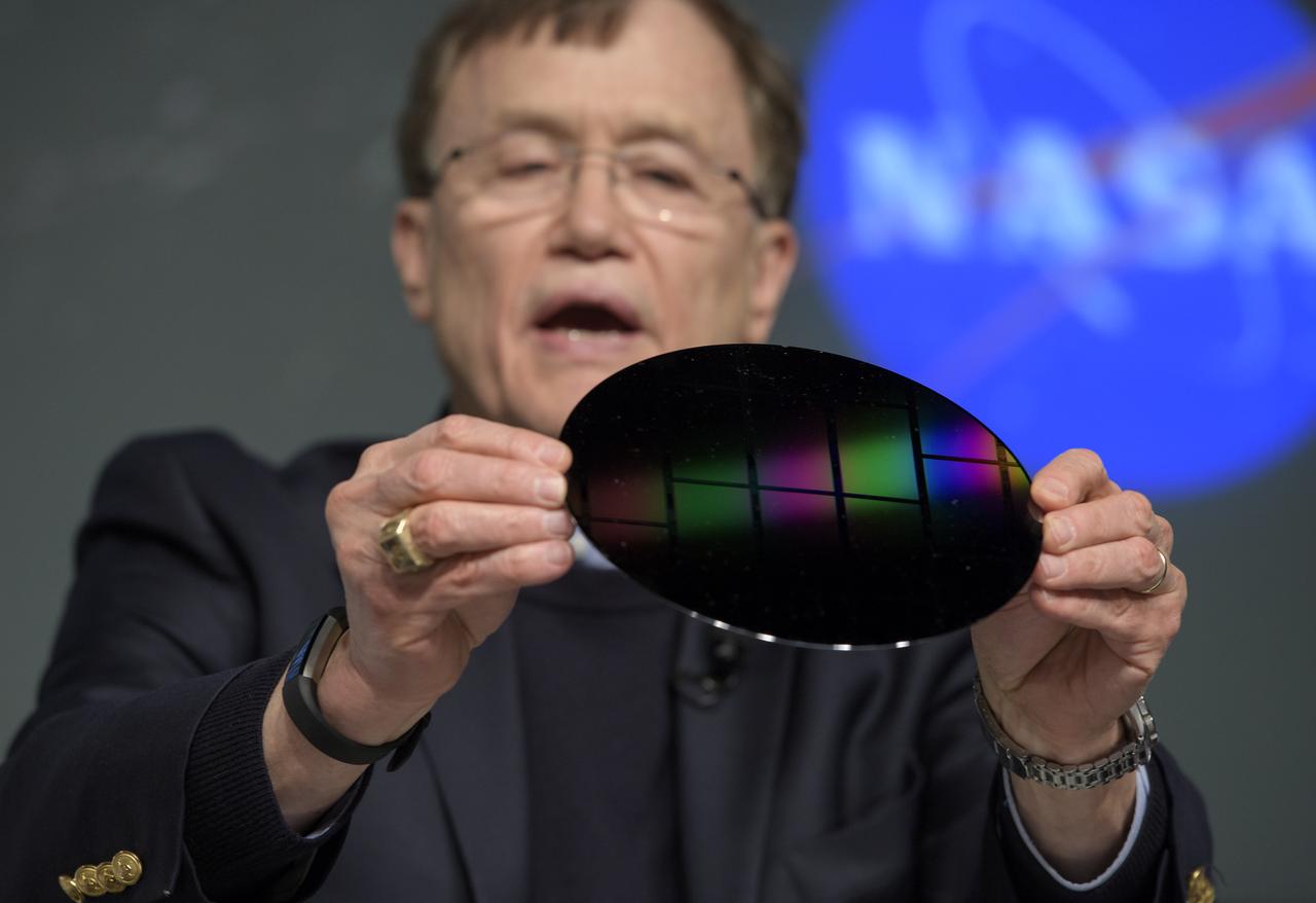 George Ricker, TESS principal investigator, MIT Kavli Institute for Astrophysics and Space Research, is seen during a media briefing holding one of the wafers from which the Transiting Exoplanet Survey Satellite (TESS) camera charge coupled device (CCD) were fabricated, Wednesday, March 28, 2018 at NASA Headquarters in Washington. Photo Credit: (NASA/Bill Ingalls)