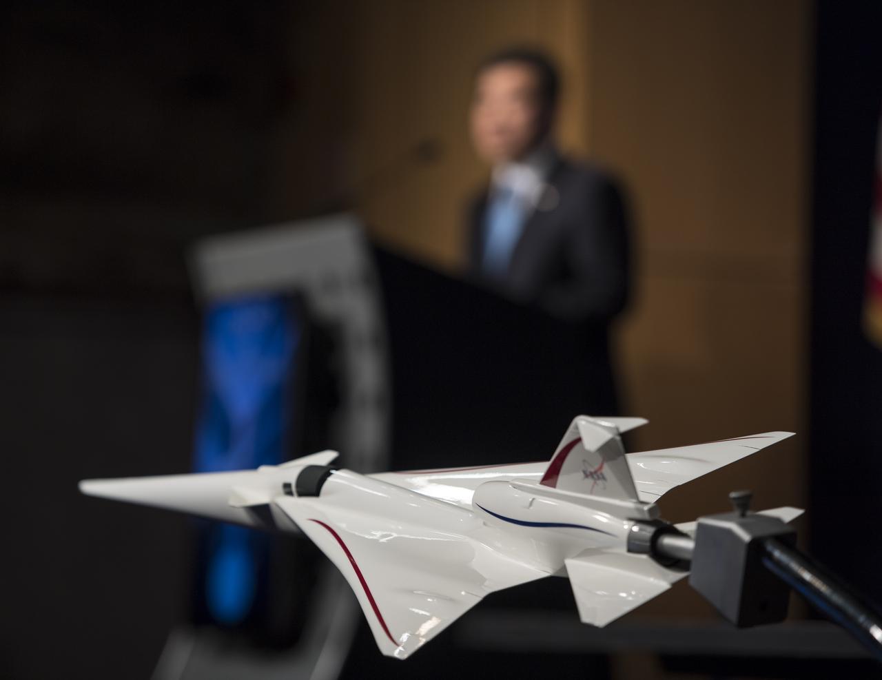 A model of the first Low Boom Flight Demonstrator is seen at a briefing on Tuesday, April 3, 2018 at NASA Headquarters in Washington. This new experimental aircraft will cut cross country travel times in half by flying faster than the speed of sound without creating a sonic boom, enabling travel from New York to Los Angeles in two hours. Photo Credit: (NASA/Aubrey Gemignani)