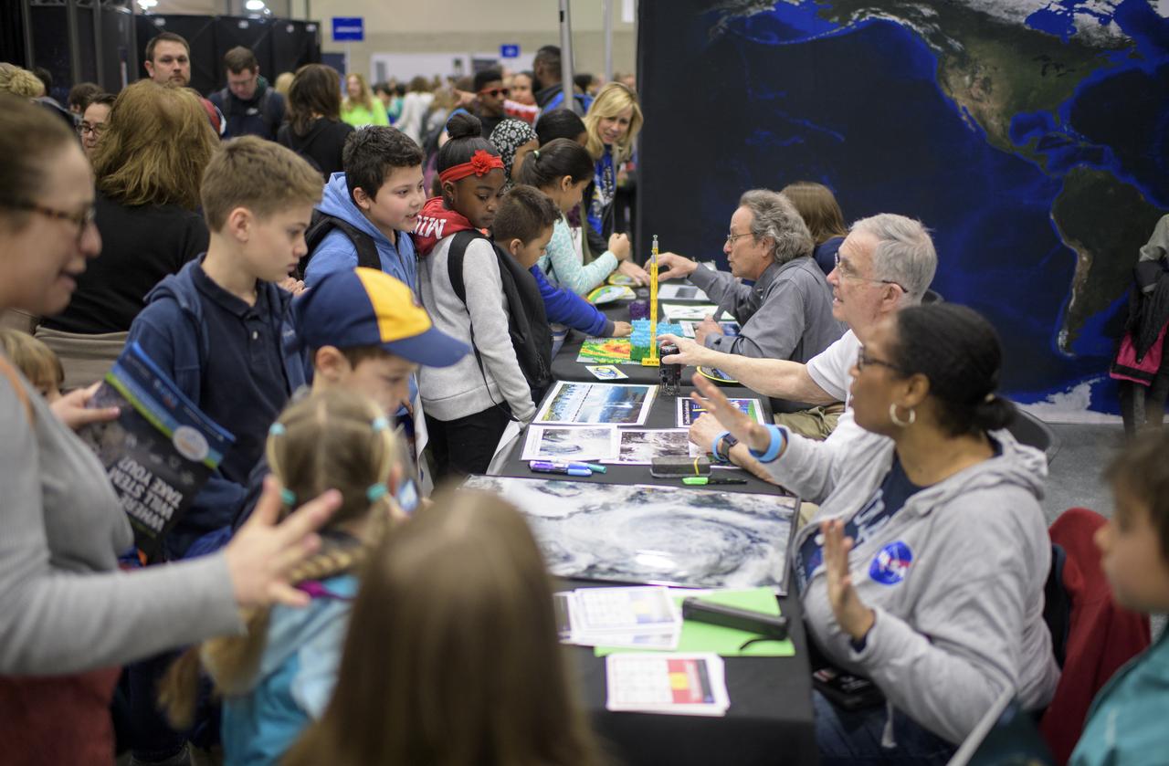 Attendees visit NASA exhibits during Sneak Peek Friday at the USA Science and Engineering Festival, Friday, April 6, 2018 at the Walter E. Washington Convention Center in Washington, DC.  The festival is open to the public April 7-8.  Photo Credit: (NASA/Joel Kowsky)