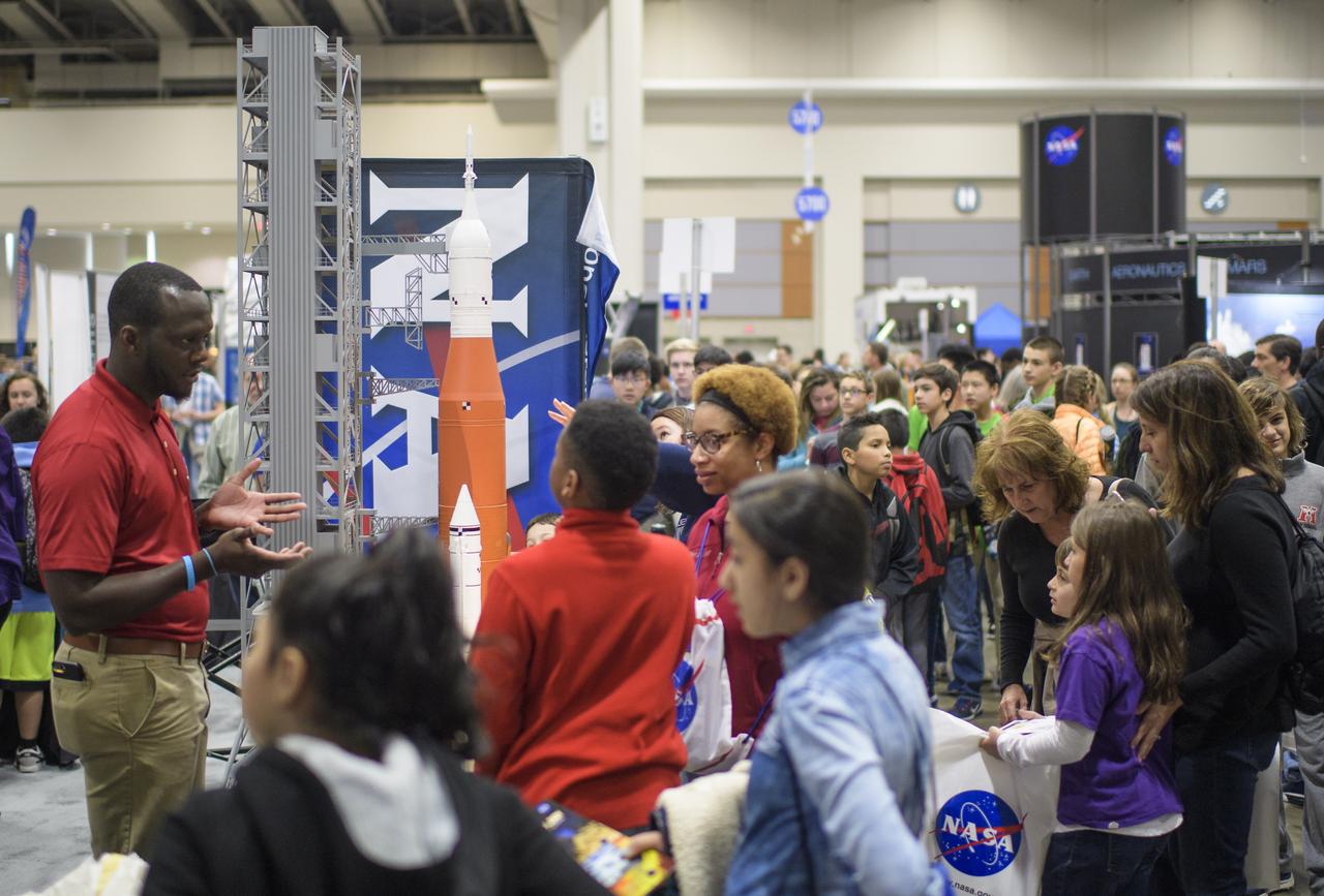 Attendees visit NASA exhibits during Sneak Peek Friday at the USA Science and Engineering Festival, Friday, April 6, 2018 at the Walter E. Washington Convention Center in Washington, DC.  The festival is open to the public April 7-8.  Photo Credit: (NASA/Joel Kowsky)