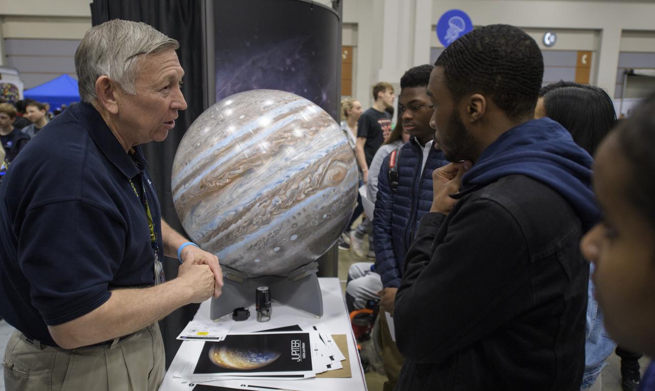 Attendees listen to a NASA staff member speak about Jupiter and NASA's Juno mission during Sneak Peek Friday at the USA Science and Engineering Festival, Friday, April 6, 2018 at the Walter E. Washington Convention Center in Washington, DC.  The festival is open to the public April 7-8.  Photo Credit: (NASA/Joel Kowsky)
