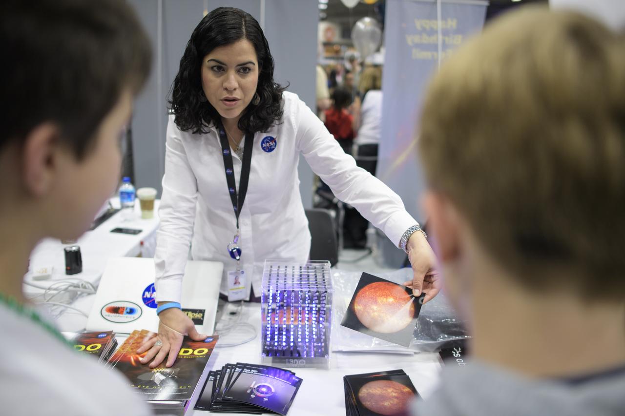 Attendees listen to a NASA staff member speak about the Sun and NASA's Solar Dynamics Observatory mission during Sneak Peek Friday at the USA Science and Engineering Festival, Friday, April 6, 2018 at the Walter E. Washington Convention Center in Washington, DC.  The festival is open to the public April 7-8.  Photo Credit: (NASA/Joel Kowsky)