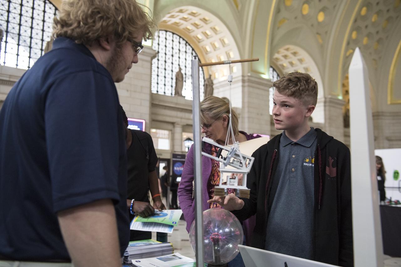 A visitor explores one of NASA's exhibits at the Earth Day event on Thursday, April 19, 2018 at Union Station in Washington, D.C. Photo Credit: (NASA/Aubrey Gemignani)
