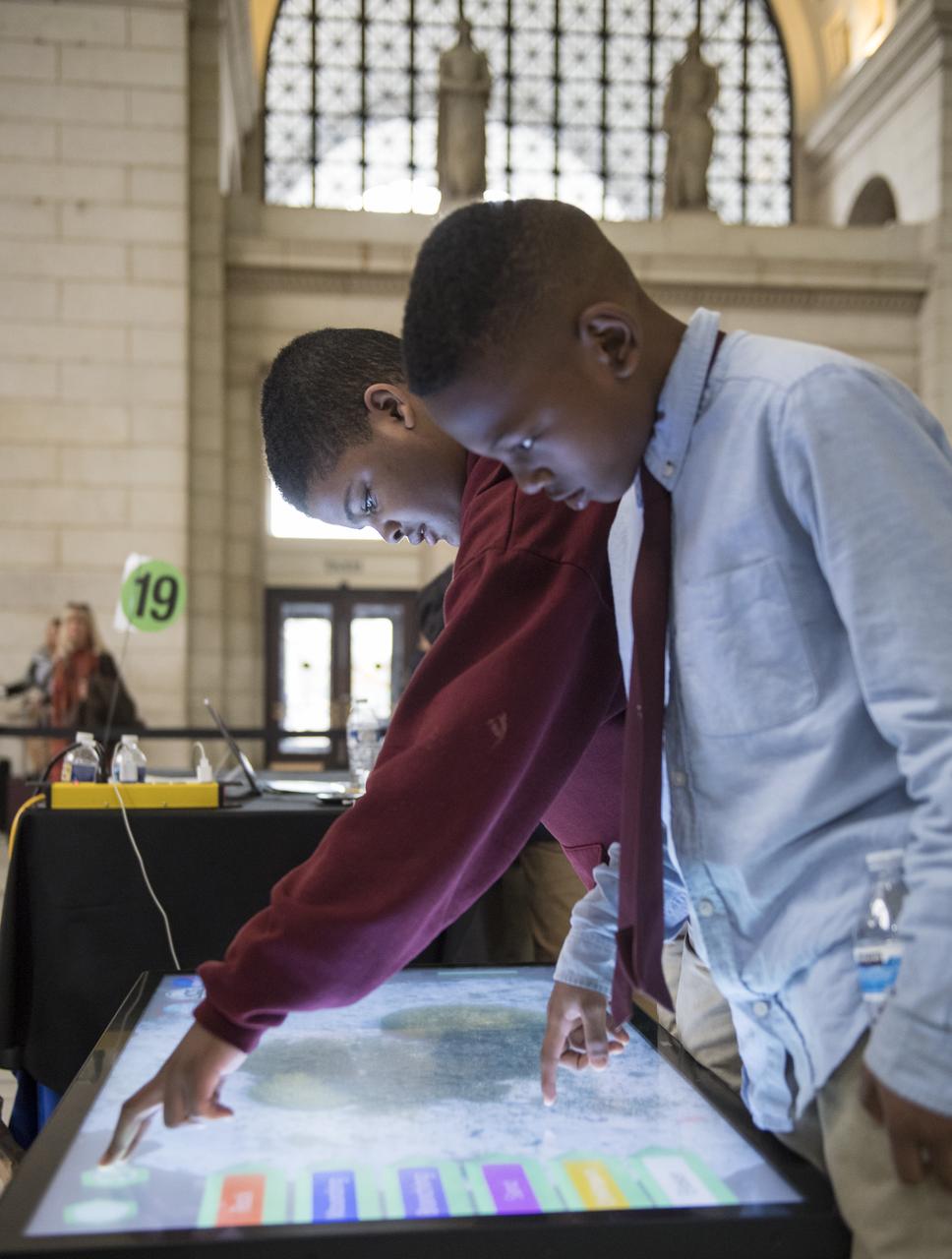 Visitors explore one of NASA's exhibits at the Earth Day event on Thursday, April 19, 2018 at Union Station in Washington, D.C. Photo Credit: (NASA/Aubrey Gemignani)