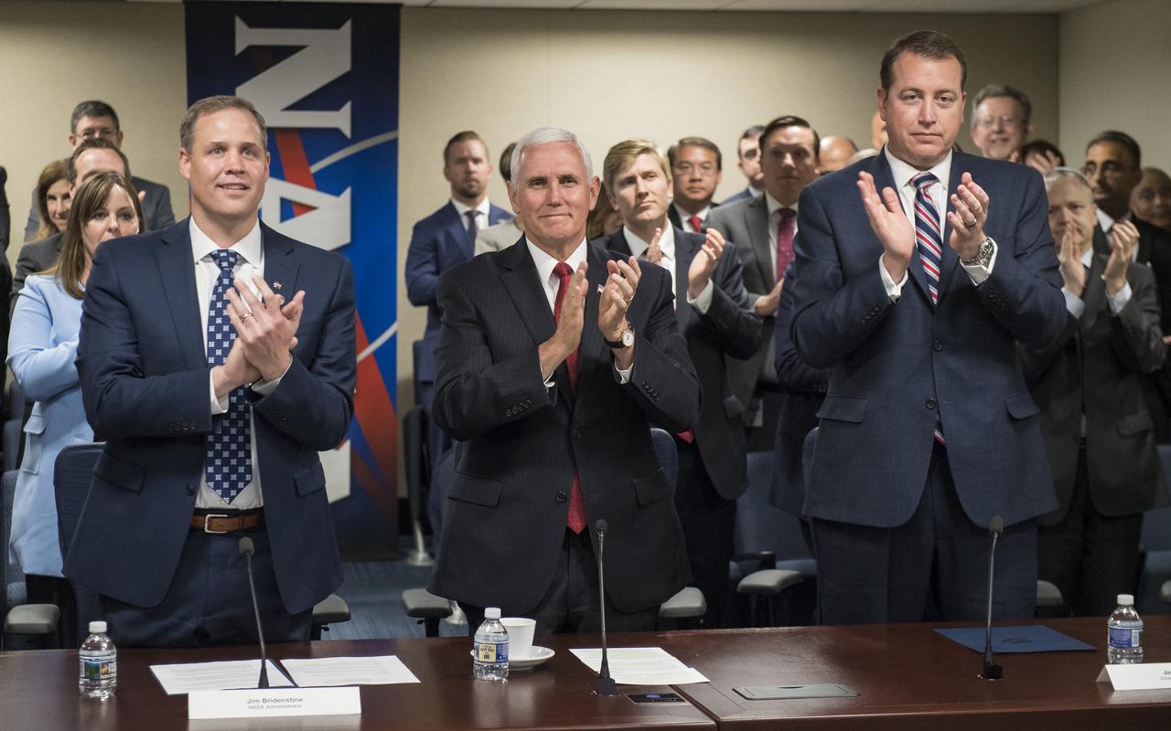 NASA Administrator Jim Bridenstine, left, Vice President Mike Pence, and NASA Chief Financial Officer Jeff DeWit, right, give a standing ovation to former acting administrator Robert Lightfoot, Monday, April 23, 2018 at NASA Headquarters in Washington. Bridenstine was just sworn in by the Vice President as NASA's 13th Administrator. Photo Credit: (NASA/Aubrey Gemignani)