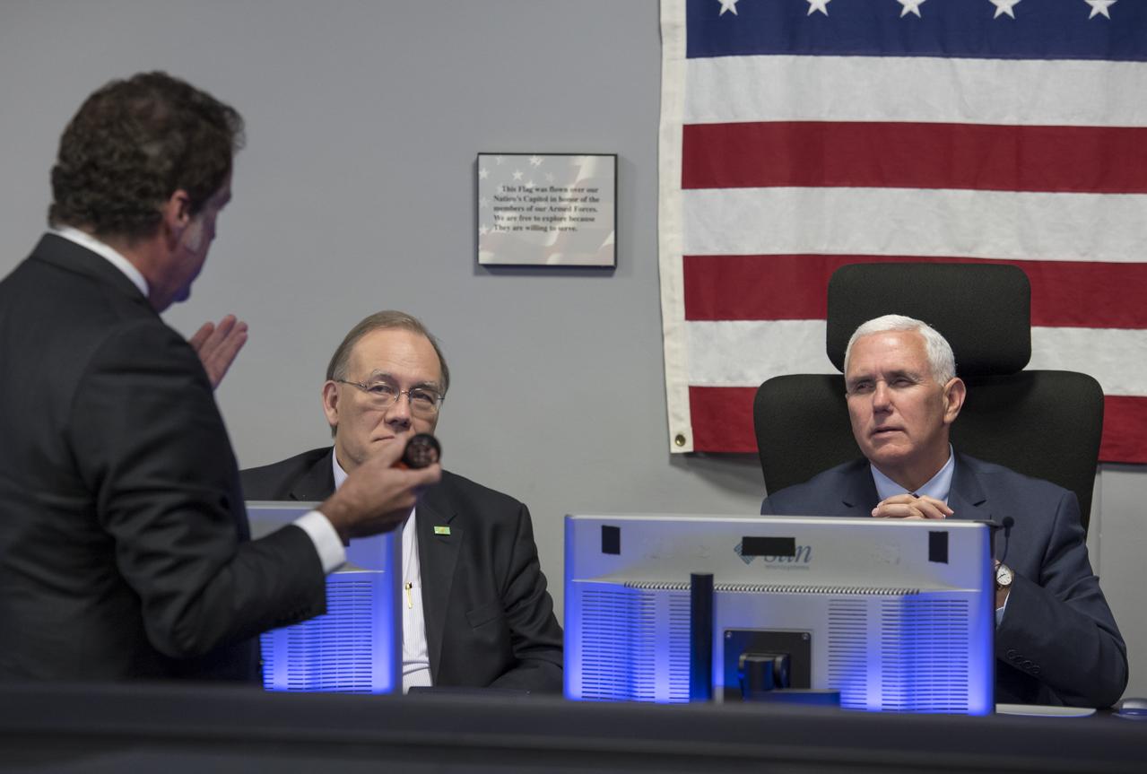 JPL Director Michael Watkins, standing, explains the history of NASA's Jet Propulsion Laboratory and the use of the Mission Support Area to Vice President Mike Pence, right, and Executive Director of the National Space Council Scott Pace during a tour of JPL, Saturday, April 28, 2018 in Pasadena, California. Photo Credit: (NASA/Bill Ingalls)