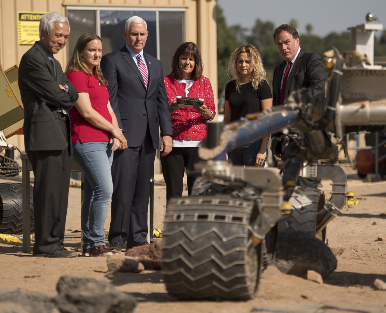 Second Lady Karen Pence gives commands to a rover nicknamed "Scarecrow" as NASA Mars Exploration Manager Li Fuk, left, Mars Curiosity Engineering Operations Team Chief Megan Lin, Vice President Mike Pence, daughter of Mike Pence, Charlotte Pence, and JPL Director Michael Watkins, right, look on, Saturday, April 28, 2018 in Pasadena, California. Scarecrow is used to test mobility of rovers on Mars. Photo Credit: (NASA/Bill Ingalls)