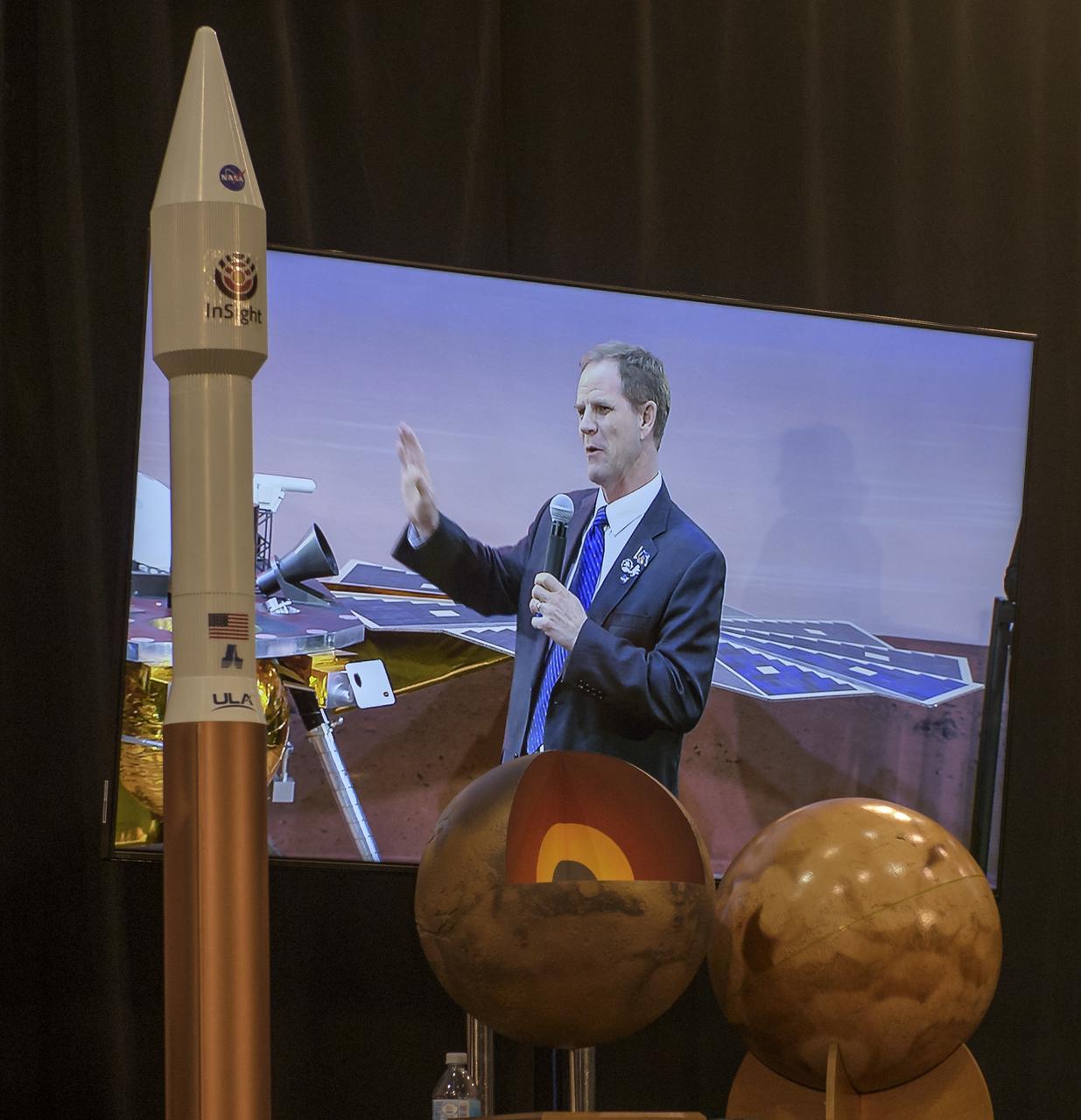 Scott Messer, United Launch Alliance program manager for NASA missions, is seen on a monitor as he discusses NASA's InSight mission during a prelaunch media briefing, Thursday, May 3, 2018, at Vandenberg Air Force Base in California. InSight, short for Interior Exploration using Seismic Investigations, Geodesy and Heat Transport, is a Mars lander designed to study the "inner space" of Mars: its crust, mantle, and core. Photo Credit: (NASA/Bill Ingalls)