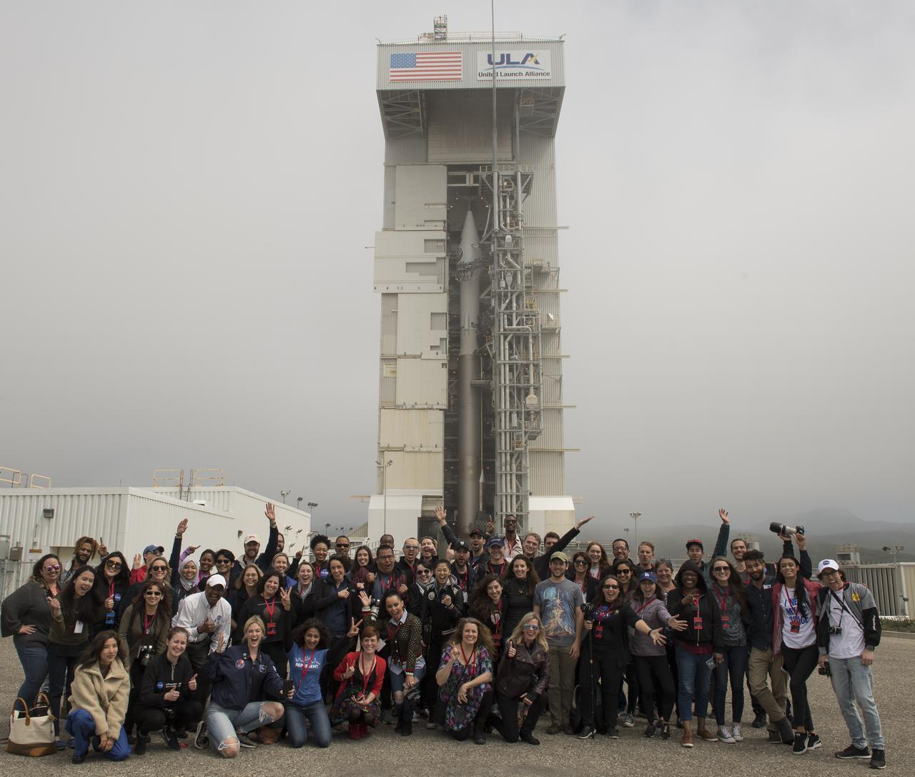 NASA social media attendees pose for a group photograph in front of the United Launch Alliance (ULA) Atlas-V rocket with NASA's InSight spacecraft onboard, Friday, May 4, 2018, at Vandenberg Air Force Base in California. InSight, short for Interior Exploration using Seismic Investigations, Geodesy and Heat Transport, is a Mars lander designed to study the "inner space" of Mars: its crust, mantle, and core. Photo Credit: (NASA/Bill Ingalls)