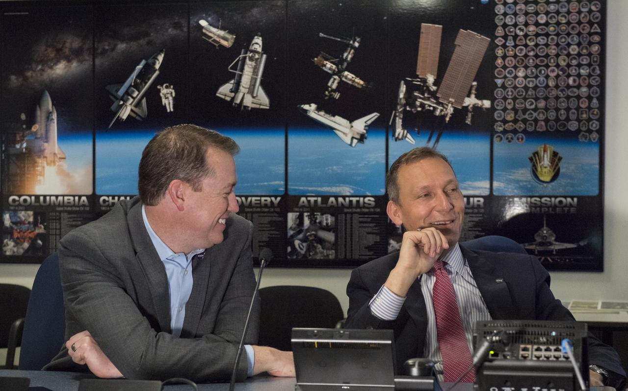 NASA Chief Financial Officer, Jeff DeWit, left, talks to NASA Associate Administrator for the Science Mission Directorate, Thomas Zurbuchen after the launch of NASA's InSight spacecraft on a United Launch Alliance (ULA) Atlas-V rocket Saturday, May 5, 2018 at NASA Headquarters in Washington. InSight, short for Interior Exploration using Seismic Investigations, Geodesy and Heat Transport, is a Mars lander designed to study the "inner space" of Mars: its crust, mantle, and core. Photo Credit: (NASA/Aubrey Gemignani)