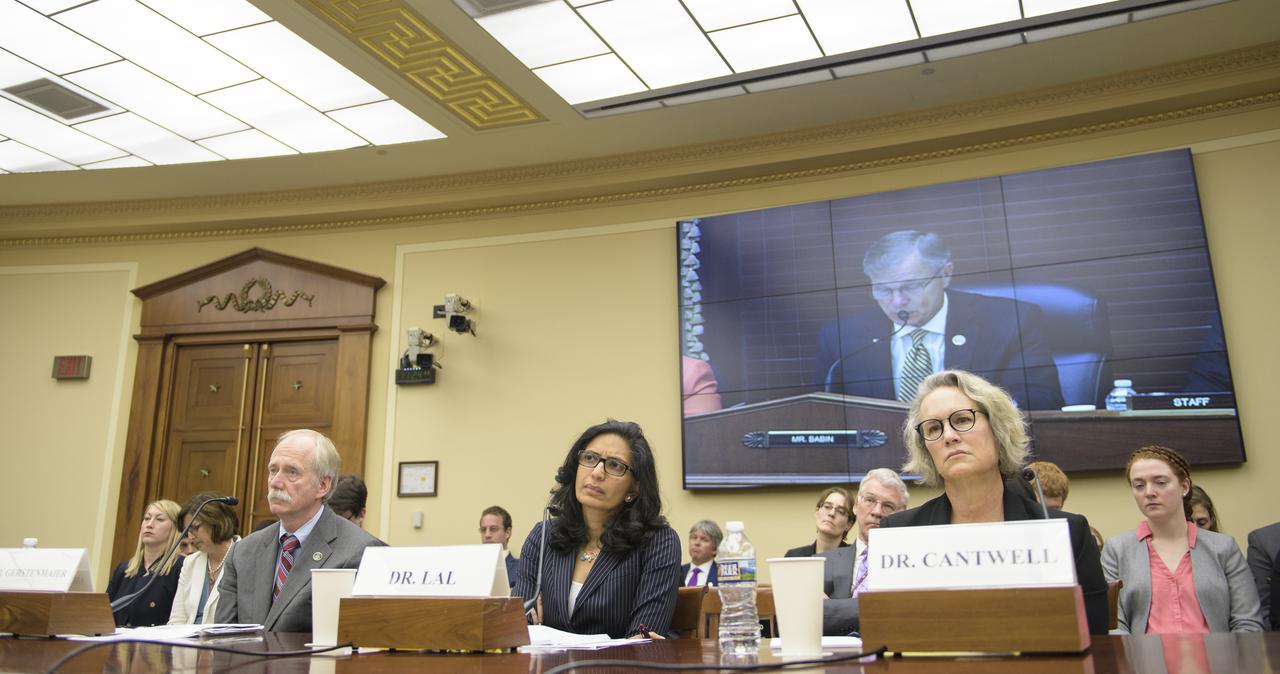 NASA Associate Administrator for the Human Exploration and Operations Mission Directorate William Gerstenmaier, left, Dr. Bhavya Lal, a researcher at the Institute for Defense Analysis's Science and Technology Policy Institute, center, and Dr. Elizabeth Cantwell, chief executive officer at the Arizona State University Research Enterprise, right, listen as Rep. Brian Babin, R-Texas, is seen on screen as he delivers an opening statement during a House Committee on Science, Space, and Technology hearing titled "America's Human Presence in Low-Earth Orbit" on Thursday, May 17, 2018 in the Rayburn House Office Building in Washington. Photo Credit: (NASA/Joel Kowsky)