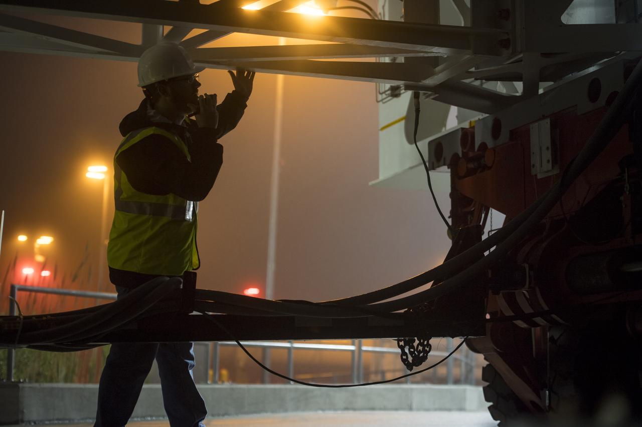 A worker watches the Orbital ATK rocket closely just before it makes its final approach to launch Pad-0A at Wallops Flight Facility Thursday, May 17, 2018 at Wallops Island, VA. The Antares will launch a Cygnus spacecraft on a cargo resupply mission to the International Space Station. The mission is Orbital ATK’s ninth contracted cargo delivery flight to the space station for NASA. Included in the 7,400 pounds of cargo onboard Cygnus, are science experiments, crew supplies, and vehicle hardware. Photo Credit: (NASA/Aubrey Gemignani)