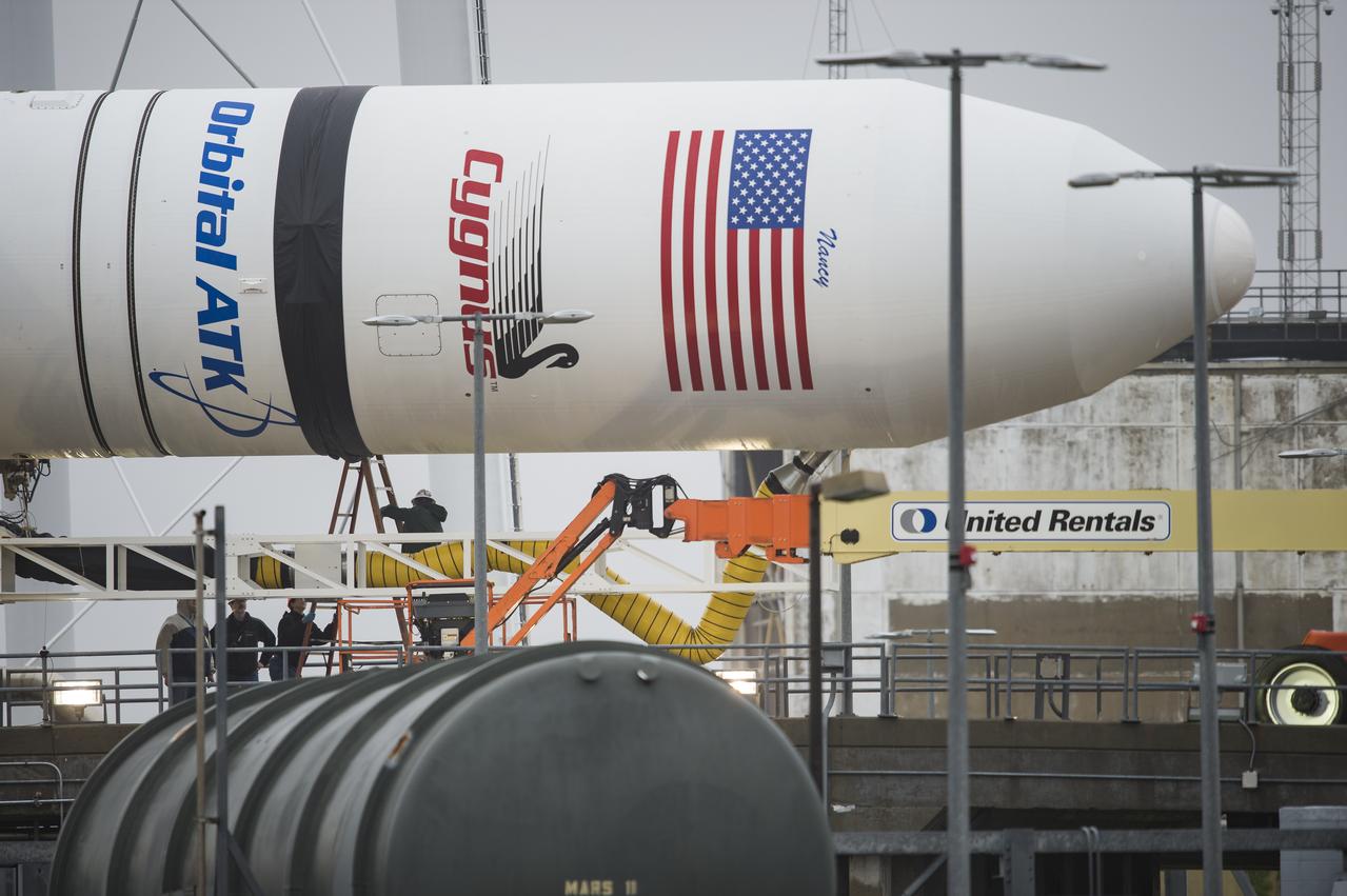 The Orbital ATK Antares rocket, with the Cygnus spacecraft onboard, is prepared to be raised at launch Pad-0A, Friday, May 18, 2018 at Wallops Flight Facility in Virginia. The Antares will launch with the Cygnus spacecraft filled with 7,400 pounds of cargo for the International Space Station (ISS), including science experiments, crew supplies, and vehicle hardware. The mission is Orbital ATK's ninth contracted cargo delivery flight to ISS for NASA. Photo Credit: (NASA/Aubrey Gemignani)
