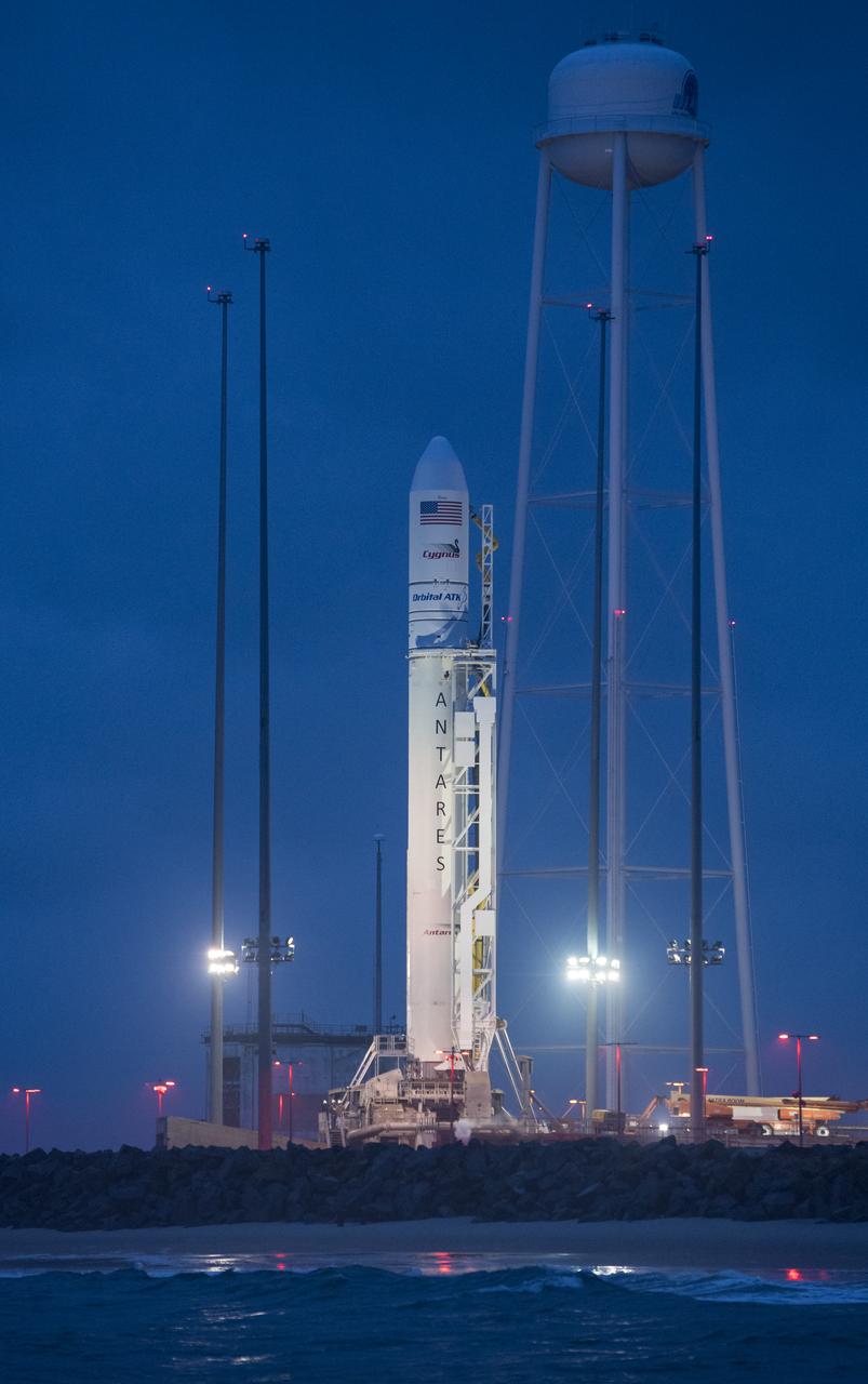 The Orbital ATK Antares rocket, with the Cygnus spacecraft onboard, is seen at launch Pad-0A, at sunrise Sunday, May 20, 2018 at Wallops Flight Facility in Virginia. The Antares will launch with the Cygnus spacecraft filled with 7,400 pounds of cargo for the International Space Station (ISS), including science experiments, crew supplies, and vehicle hardware. The mission is Orbital ATK's ninth contracted cargo delivery flight to ISS for NASA. Photo Credit: (NASA/Aubrey Gemignani)