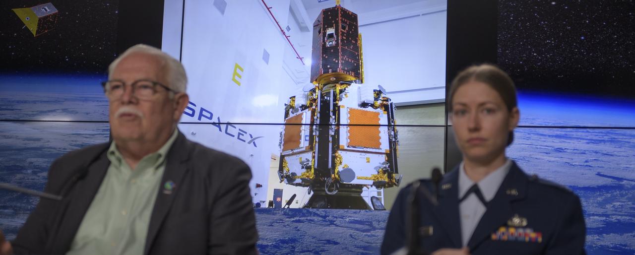 A photo showing the The twin GRACE-FO spacecraft installed on top of the five Iridium NEXT communications satellites is seen as experts discuss the Gravity Recovery and Climate Experiment Follow-On mission during a prelaunch media briefing, Monday, May 21, 2018, at Vandenberg Air Force Base in California. The twin GRACE-FO spacecraft will measure changes in how mass is redistributed within and among Earth's atmosphere, oceans, land and ice sheets, as well as within Earth itself. Photo Credit: (NASA/Bill Ingalls)