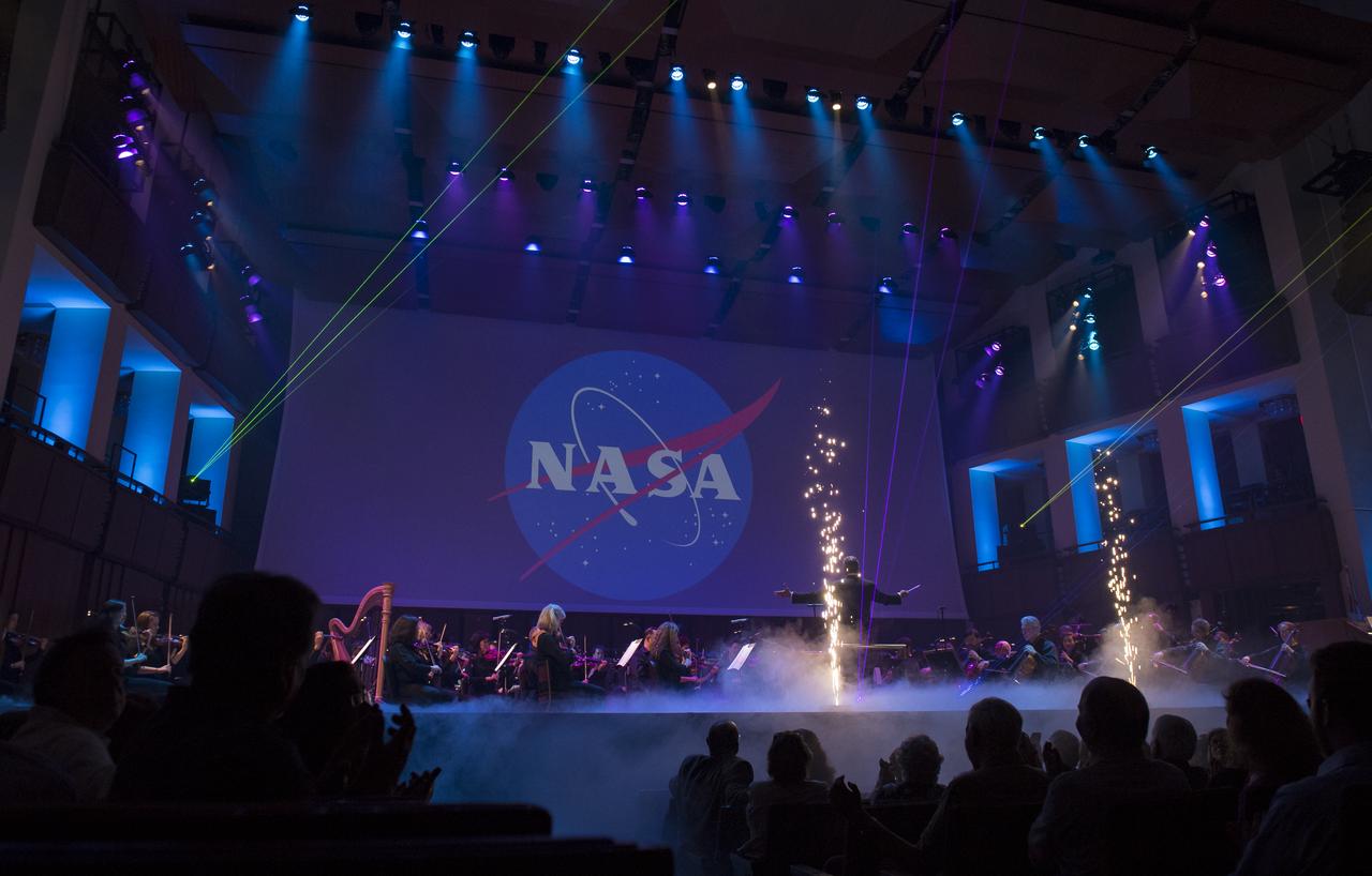 Conductor Emil de Cou leads the final performance of the National Symphony Orchestra during the "Space, the Next Frontier" event celebrating NASA's 60th Anniversary, Friday, June 1, 2018 at the John F. Kennedy Center for the Performing Arts in Washington. The event featured music inspired by space including artists will.i.am, Grace Potter, Coheed & Cambria, John Cho, and guest Nick Sagan, son of Carl Sagan. Photo Credit: (NASA/Aubrey Gemignani)