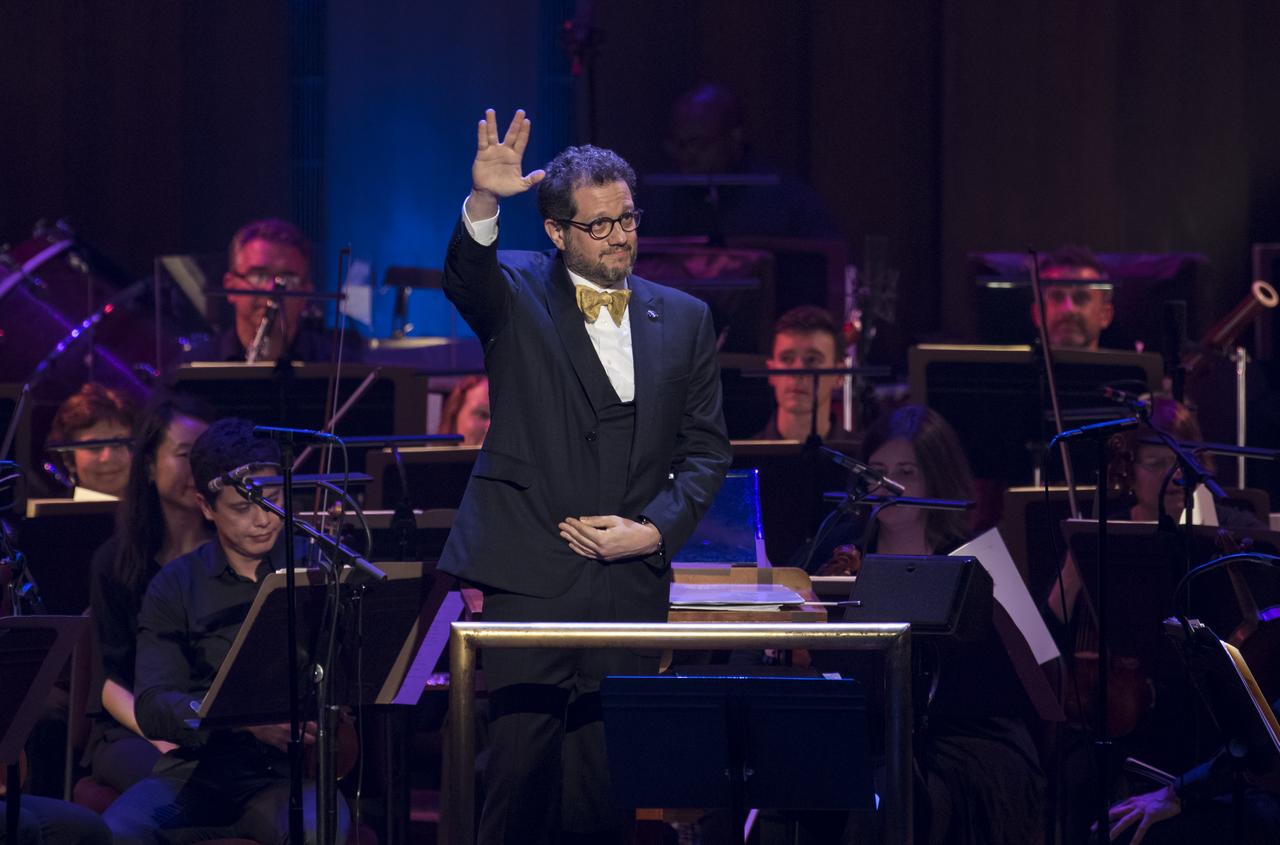 Star Trek composer Michael Giacchino does the Vulcan salute after conducting the National Symphony Orchestra during the "Space, the Next Frontier" event celebrating NASA's 60th Anniversary, Friday, June 1, 2018 at the John F. Kennedy Center for the Performing Arts in Washington. The event featured music inspired by space including artists will.i.am, Grace Potter, Coheed & Cambria, John Cho, and guest Nick Sagan, son of Carl Sagan. Photo Credit: (NASA/Aubrey Gemignani)