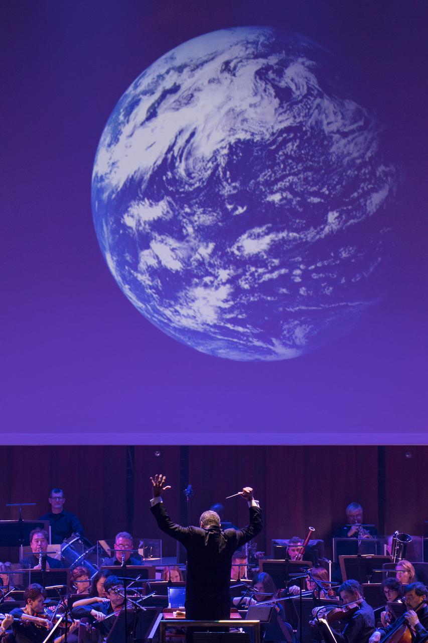Conductor Emil de Cou leads the National Symphony Orchestra during the "Space, the Next Frontier" event celebrating NASA's 60th Anniversary, Friday, June 1, 2018 at the John F. Kennedy Center for the Performing Arts in Washington. The event featured music inspired by space including artists will.i.am, Grace Potter, Coheed & Cambria, John Cho, and guest Nick Sagan, son of Carl Sagan. Photo Credit: (NASA/Aubrey Gemignani)