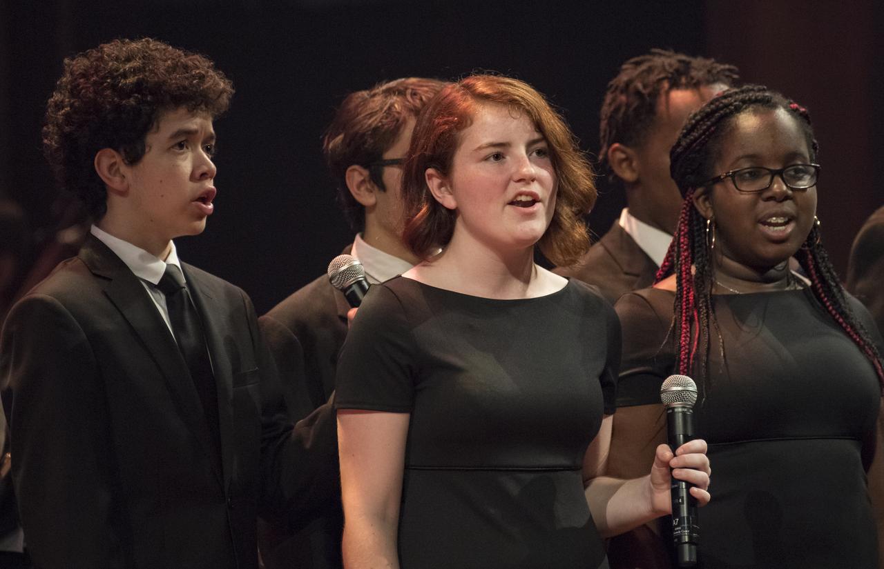 Students provide backup vocals during a performance of Will.i.am's "Reach for the Stars" at the "National Symphony Orchestra Pops: Space, the Next Frontier" event celebrating NASA's 60th Anniversary, Friday, June 1, 2018 at the John F. Kennedy Center for the Performing Arts in Washington. The event featured music inspired by space including artists will.i.am, Grace Potter, Coheed & Cambria, John Cho, and guest Nick Sagan, son of Carl Sagan. Photo Credit: (NASA/Aubrey Gemignani)