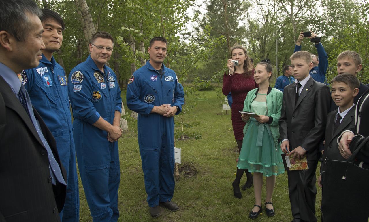 Japan Aerospace Exploration Agency astronauts, Koichi Wakata, left, and Takuya Onishi, along with NASA astronauts Doug Wheelock, and Kjell Lindgren, right, meet with children from a local orphanage at the Cosmonaut Hotel, Saturday, June 2, 2018 in Karaganda, Kazakhstan. The astronauts were in Karaganda to help support the Expedition 55 crew Soyuz landing from the International Space Station. Photo Credit: (NASA/Bill Ingalls)