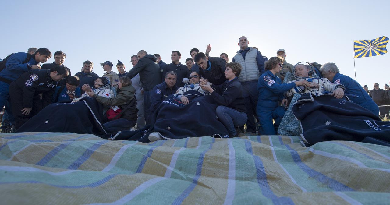 Japan Aerospace Exploration Agency (JAXA) astronaut Norishige Kanai, left, Roscosmos cosmonaut Anton Shkaplerov, center, and NASA astronaut Scott Tingle sit in chairs outside the Soyuz MS-07 spacecraft after they landed in a remote area near the town of Zhezkazgan, Kazakhstan on Sunday, June 3, 2018. Shkaplerov, Tingle, and Kanai are returning after 168 days in space where they served as members of the Expedition 54 and 55 crews onboard the International Space Station. Photo Credit: (NASA/Bill Ingalls)