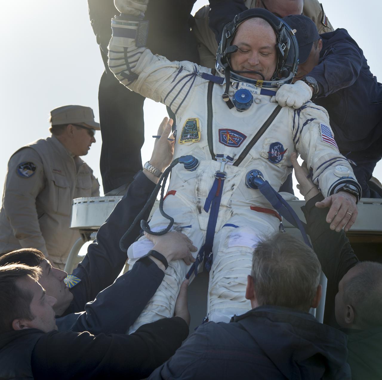 NASA astronaut Scott Tingle is helped out of the Soyuz MS-07 spacecraft just minutes after he and fellow Expedition 55 crew mates, Roscosmos cosmonaut Anton Shkaplerov, and Japan Aerospace Exploration Agency (JAXA) astronaut Norishige Kanai, landed in a remote area near the town of Zhezkazgan, Kazakhstan on Sunday, June 3, 2018. Shkaplerov, Tingle, and Kanai are returning after 168 days in space where they served as members of the Expedition 54 and 55 crews onboard the International Space Station. Photo Credit: (NASA/Bill Ingalls)