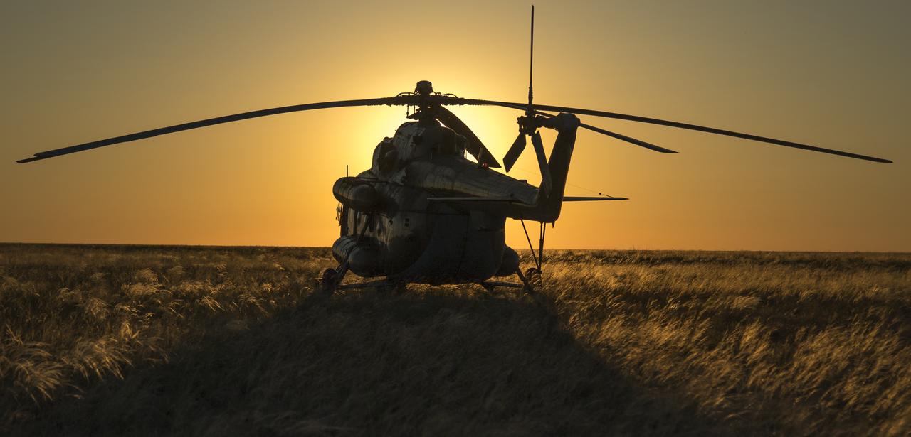 A Russian MI-8 helicopter is seen at the landing zone after Expedition 55 crew members Anton Shkaplerov of Roscosmos, Scott Tingle of NASA, and Norishige Kanai of the Japan Aerospace Exploration Agency (JAXA) landed in their Soyuz MS-07 spacecraft near the town of Zhezkazgan, Kazakhstan on Sunday, June 3, 2018. Shkaplerov, Tingle, and Kanai are returning after 168 days in space where they served as members of the Expedition 54 and 55 crews onboard the International Space Station. Photo Credit: (NASA/Bill Ingalls)