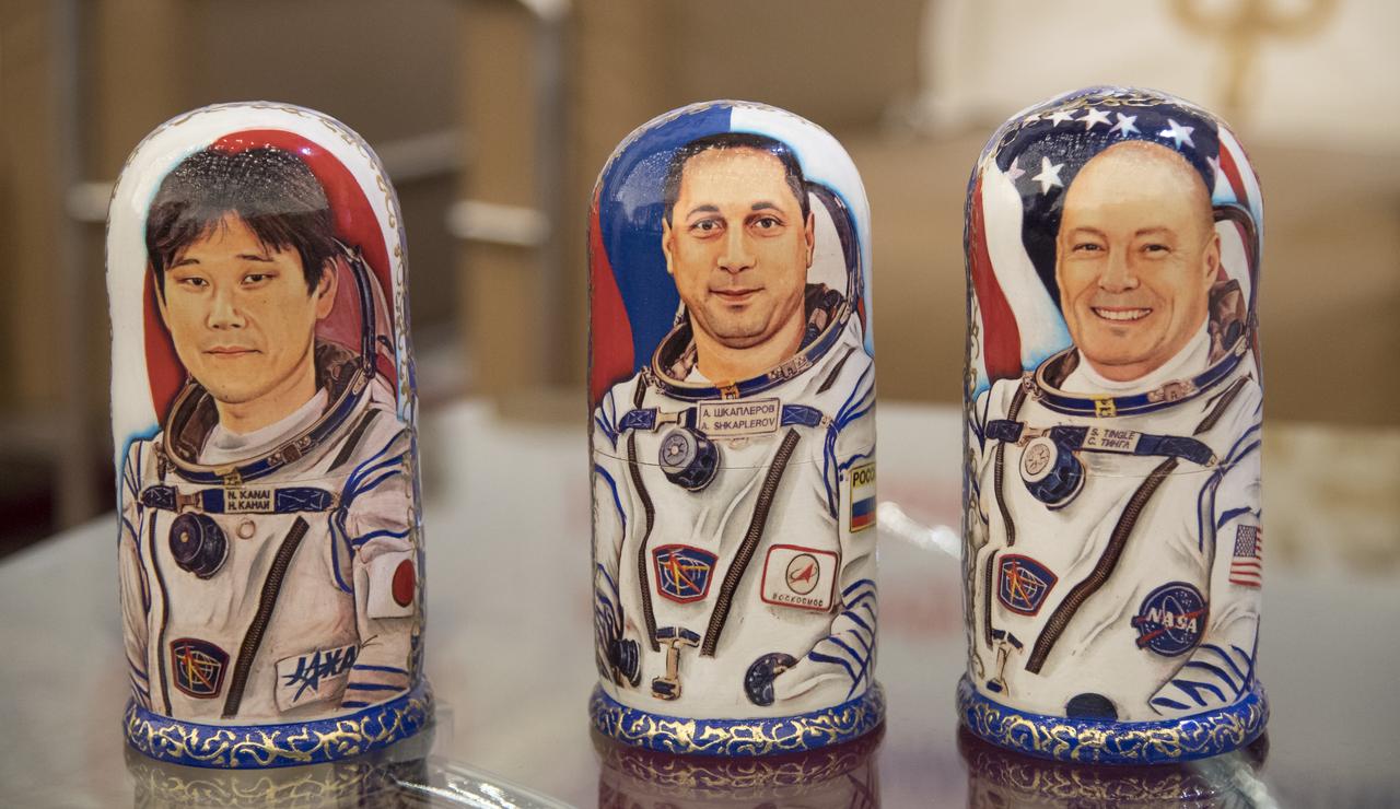 Matryoshka Dolls representing Expedition 55 crew members Norishige Kanai of the Japan Aerospace Exploration Agency (JAXA), left, Roscosmos cosmonaut Anton Shkaplerov, center, and NASA astronaut Scott Tingle are seen at a Karaganda Airport welcome ceremony in Kazakhstan on Sunday, June 3, 2018. Shkaplerov, Tingle, and Kanai are returning after 168 days in space where they served as members of the Expedition 54 and 55 crews onboard the International Space Station. Photo Credit: (NASA/Bill Ingalls)