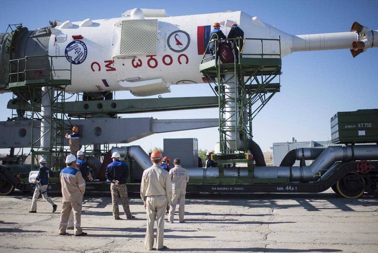 Workers prepare to raise the Soyuz rocket into a vertical position on the launch pad, Monday, June 4, 2018 at the Baikonur Cosmodrome in Kazakhstan. Expedition 56 Soyuz Commander Sergey Prokopyev of Roscosmos, flight engineer Serena Auñón-Chancellor of NASA, and flight engineer Alexander Gerst of ESA (European Space Agency) are scheduled to launch aboard their Soyuz MS-09 spacecraft at 7:12 a.m. Eastern time (5:12 p.m. Baikonur time), on Wednesday, June 6. Photo Credit: (NASA/Joel Kowsky)