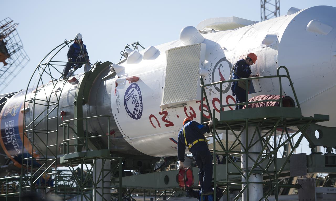 Workers prepare to raise the Soyuz rocket into a vertical position on the launch pad, Monday, June 4, 2018 at the Baikonur Cosmodrome in Kazakhstan. Expedition 56 Soyuz Commander Sergey Prokopyev of Roscosmos, flight engineer Serena Auñón-Chancellor of NASA, and flight engineer Alexander Gerst of ESA (European Space Agency) are scheduled to launch aboard their Soyuz MS-09 spacecraft at 7:12 a.m. Eastern time (5:12 p.m. Baikonur time), on Wednesday, June 6. Photo Credit: (NASA/Joel Kowsky)
