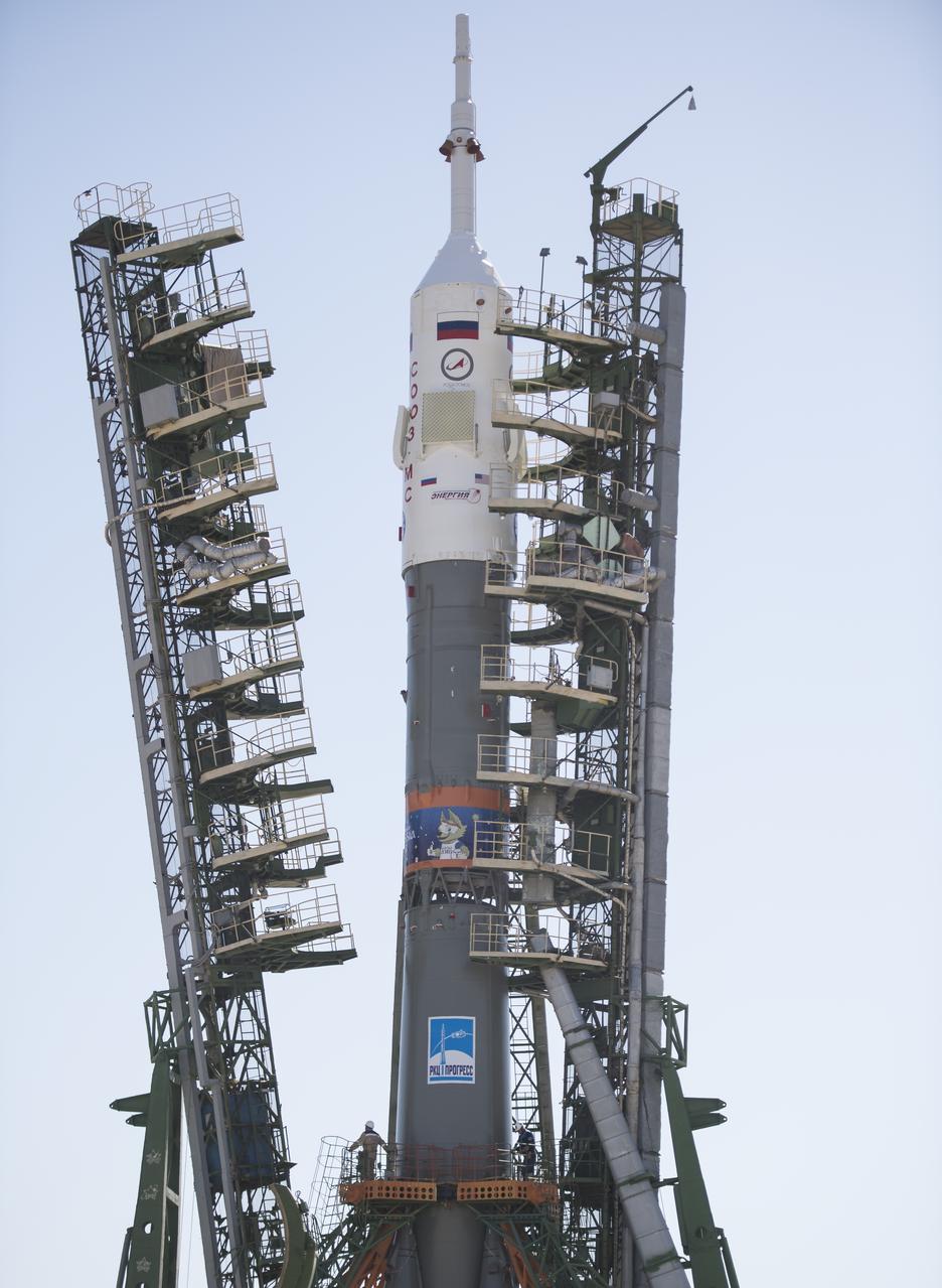 The Soyuz rocket is seen on the launch pad as the service structure arms are closed around it, Monday, June 4, 2018 at the Baikonur Cosmodrome in Kazakhstan. Expedition 56 Soyuz Commander Sergey Prokopyev of Roscosmos, flight engineer Serena Auñón-Chancellor of NASA, and flight engineer Alexander Gerst of ESA (European Space Agency) are scheduled to launch aboard their Soyuz MS-09 spacecraft at 7:12 a.m. Eastern time (5:12 p.m. Baikonur time), on Wednesday, June 6. Photo Credit: (NASA/Joel Kowsky)