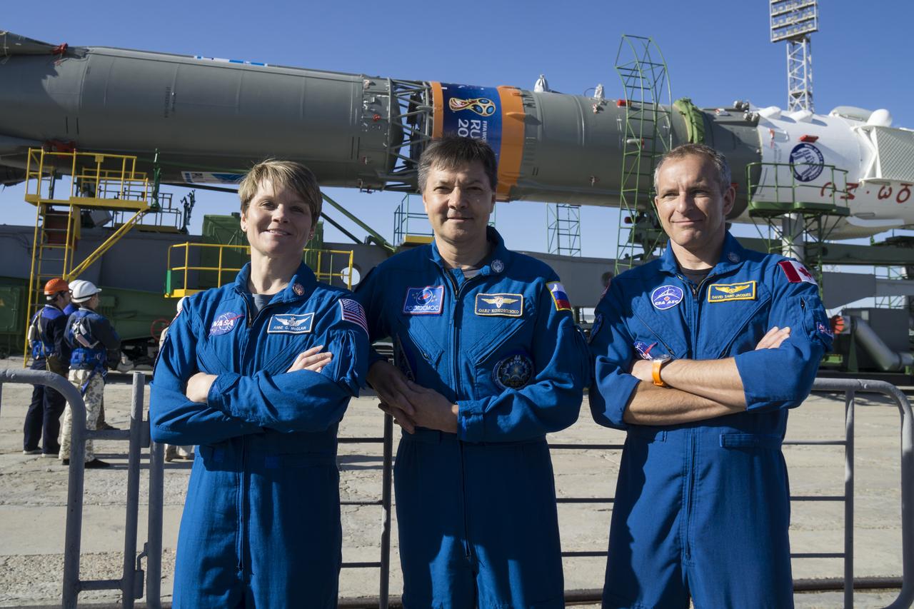 Expedition 56 backup crew members Anne McClain of NASA, left, Oleg Kononenko of Roscosmos, center, and David Saint-Jacques of the Canadian Space Agency, right, pose for a picture as the Soyuz rocket arrives at the launch pad after being rolled out by train, Monday, June 4, 2018 at the Baikonur Cosmodrome in Kazakhstan. Expedition 56 Soyuz Commander Sergey Prokopyev of Roscosmos, flight engineer Serena Auñón-Chancellor of NASA, and flight engineer Alexander Gerst of ESA (European Space Agency) are scheduled to launch aboard their Soyuz MS-09 spacecraft at 7:12 a.m. Eastern time (5:12 p.m. Baikonur time), on Wednesday, June 6. Photo Credit: (NASA/Victor Zelentsov)