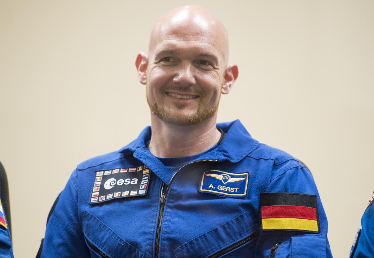 Expedition 56 flight engineer Alexander Gerst of ESA (European Space Agency) is seen in quarantine, behind glass, during a press conference, Tuesday, June 5, 2018 a the Cosmonaut Hotel in Baikonur, Kazakhstan. Gerst, Soyuz Commander Sergey Prokopyev of Roscosmos, and flight engineer Serena Auñón-Chancellor of NASA are scheduled to launch to the International Space Station aboard the Soyuz MS-09 spacecraft on Wednesday, June 6.  Photo Credit: (NASA/Joel Kowsky)
