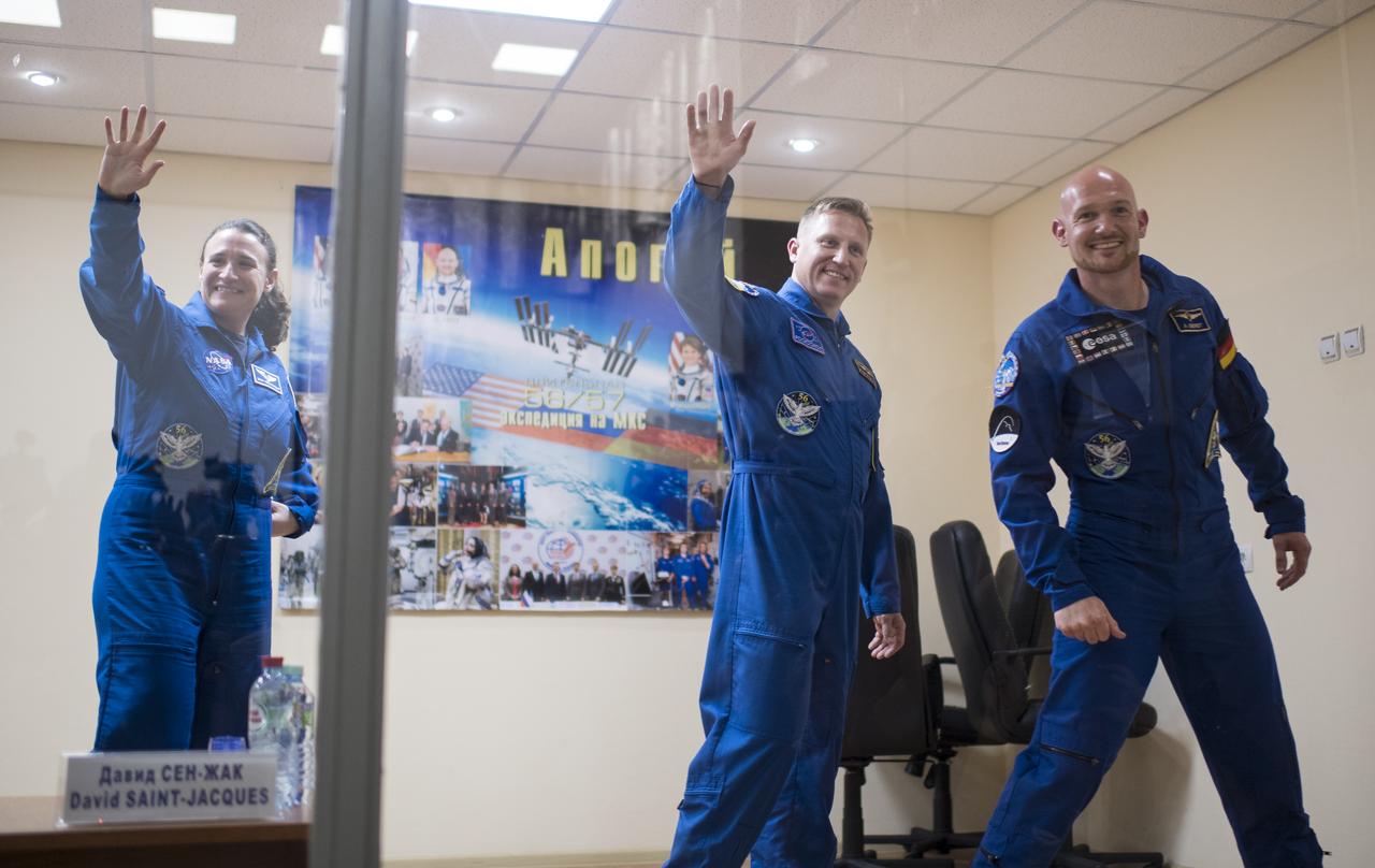 Expedition 56 flight engineer Serena Auñón-Chancellor of NASA, left, Soyuz Commander Sergey Prokopyev of Roscosmos, center, and flight engineer Alexander Gerst of ESA (European Space Agency) are seen as they leave a press conference, Tuesday, June 5, 2018 a the Cosmonaut Hotel in Baikonur, Kazakhstan. Auñón-Chancellor, Prokopyev, and Gerst are scheduled to launch to the International Space Station aboard the Soyuz MS-09 spacecraft on Wednesday, June 6.  Photo Credit: (NASA/Joel Kowsky)